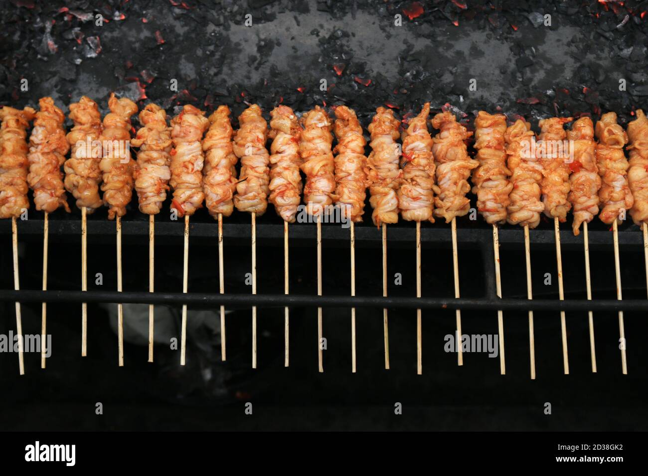 Chicken Satay or Chicken skin satay is grilled chicken skewers marinated with spices and red chili sauce Stock Photo
