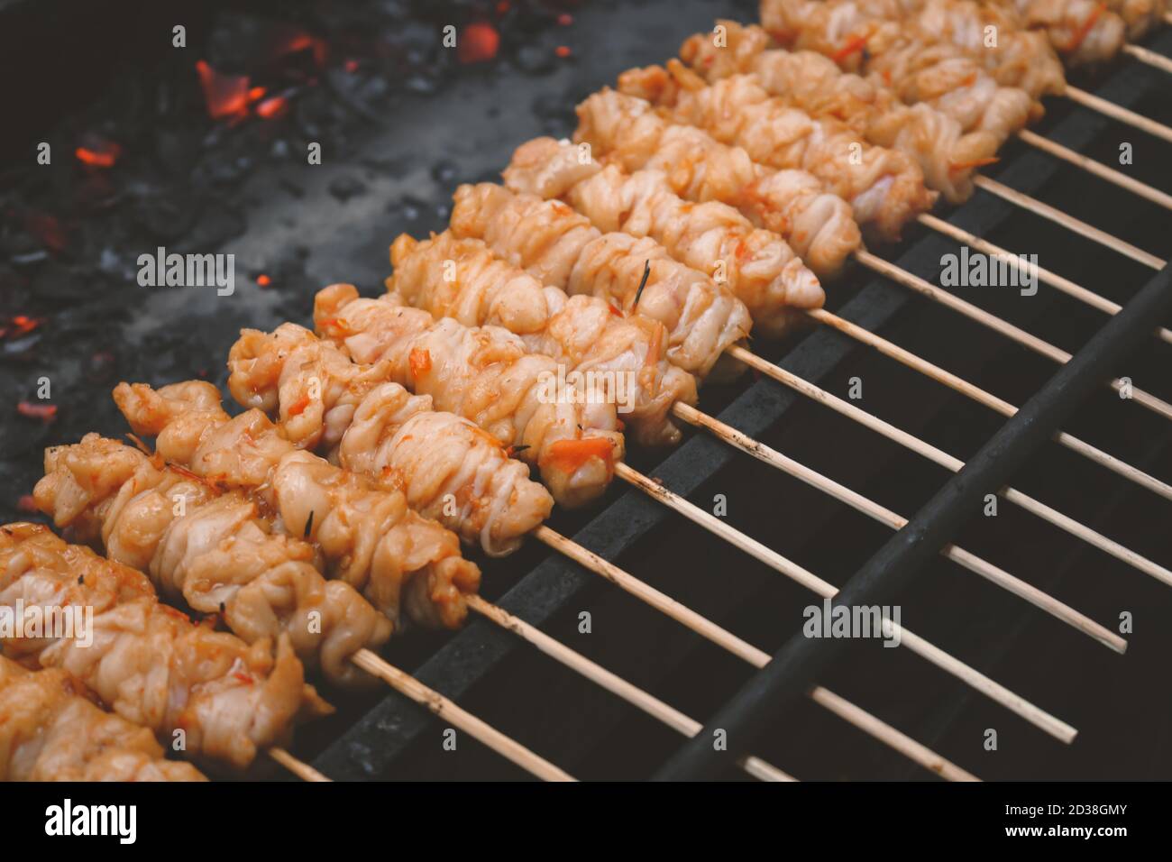 Chicken Satay or Chicken skin satay is grilled chicken skewers marinated with spices and red chili sauce Stock Photo
