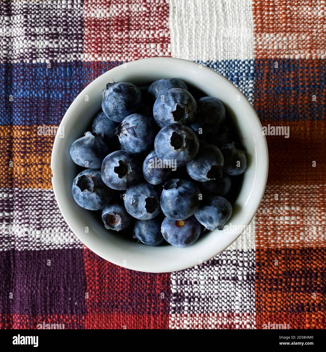 fresh blueberries in a bowl over a fall tablecloth Stock Photo
