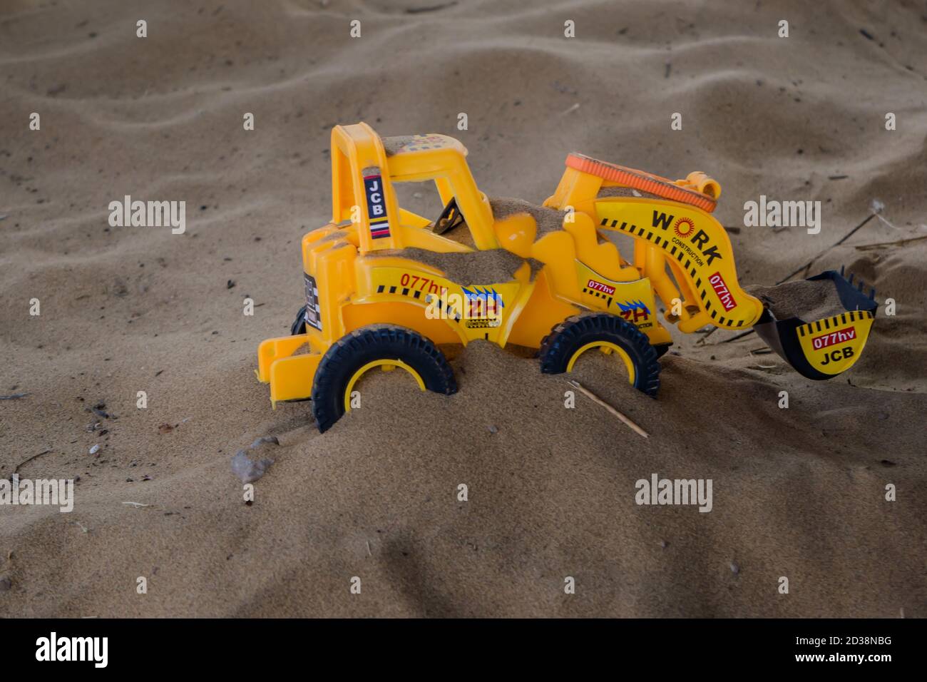 JCB Toy working on send, Construction Toys Stock Photo