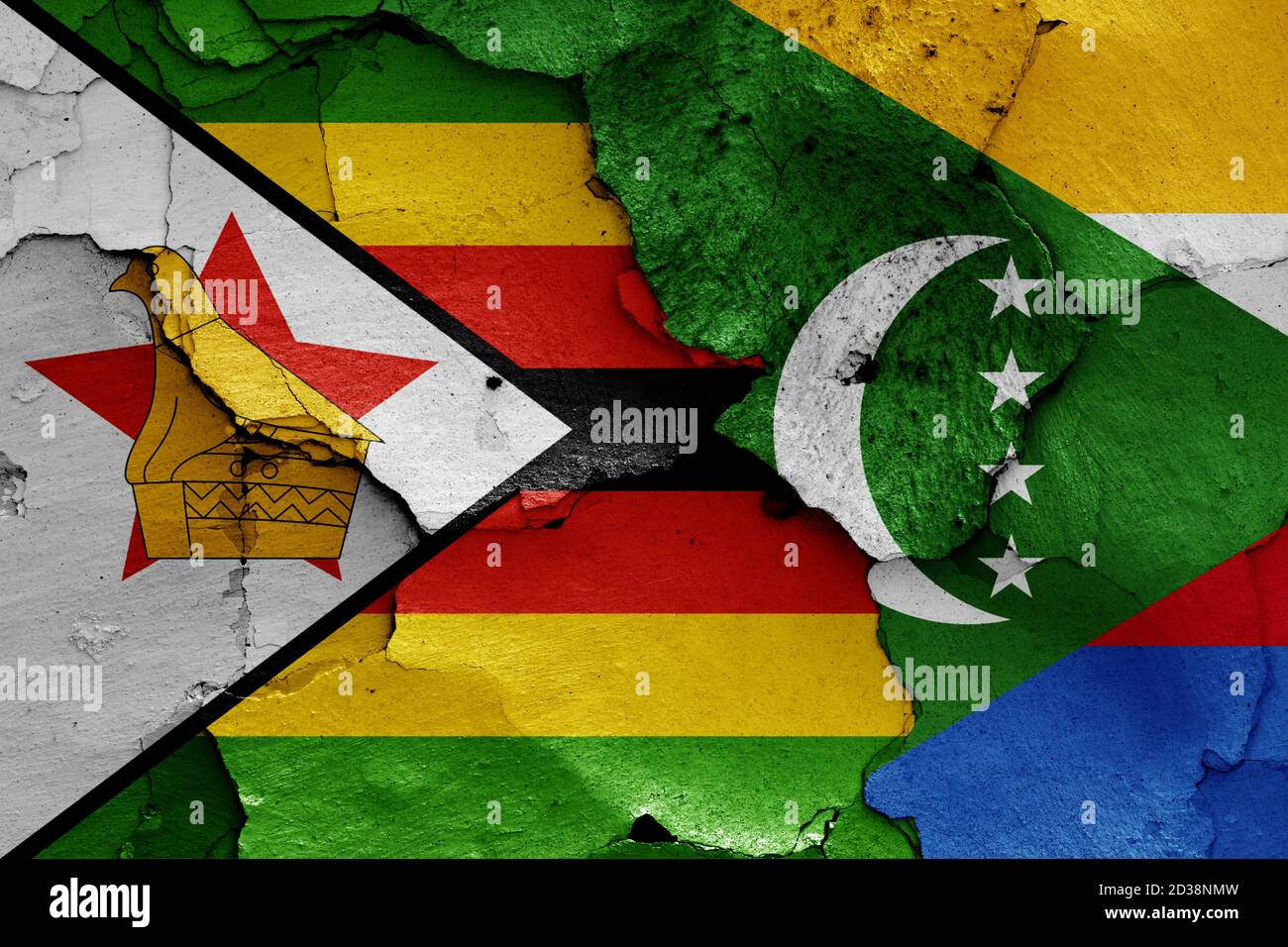 flags of Zimbabwe and Comoros painted on cracked wall Stock Photo