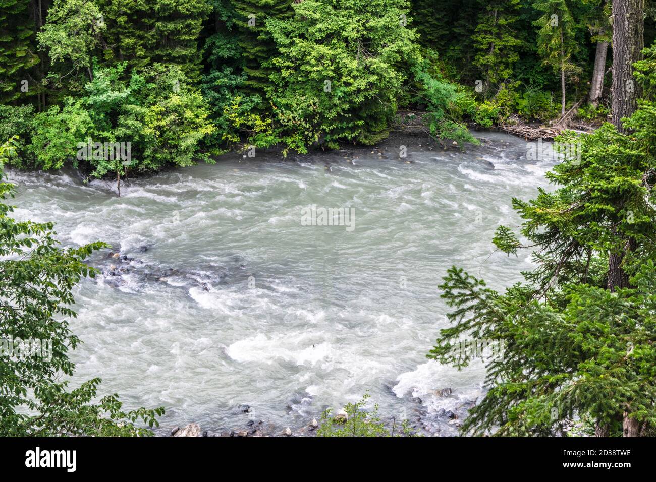 the water of a stormy mountain river flowing among stones and boulders ...