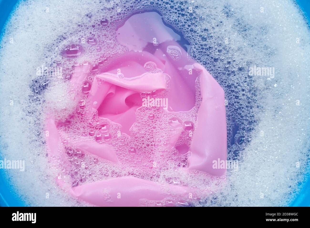 Color clothes soak in powder detergent water dissolution. Laundry ...