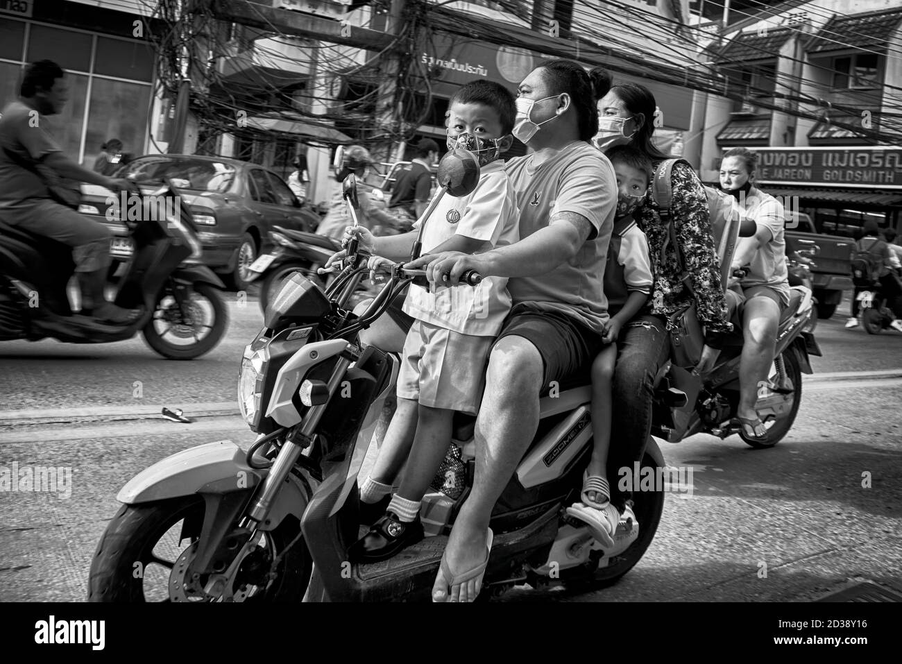 Thailand motorbike people. Thailand school run with father and mother