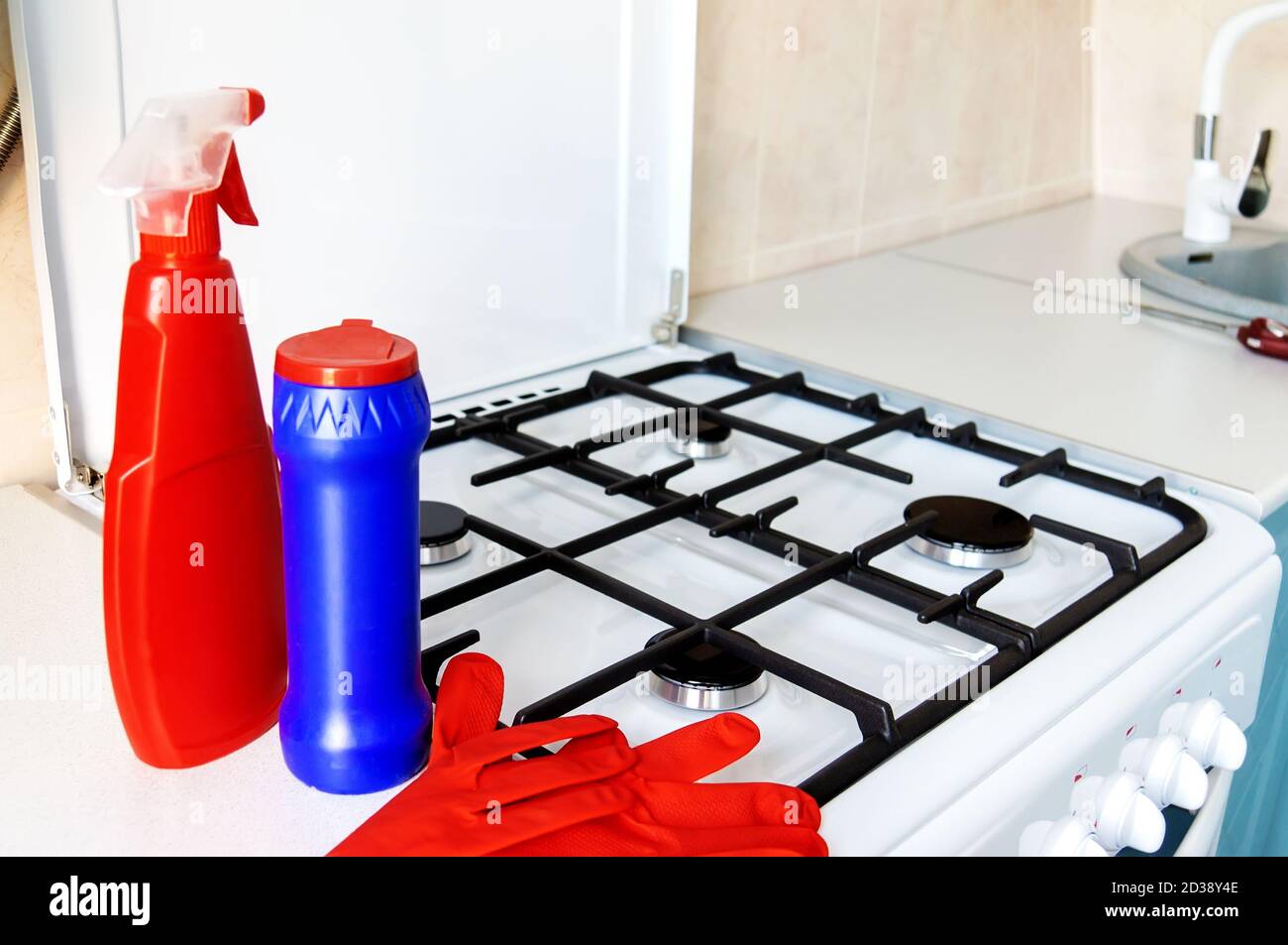 cleaning of the kitchen. Cleaning the gas stove with detergents and