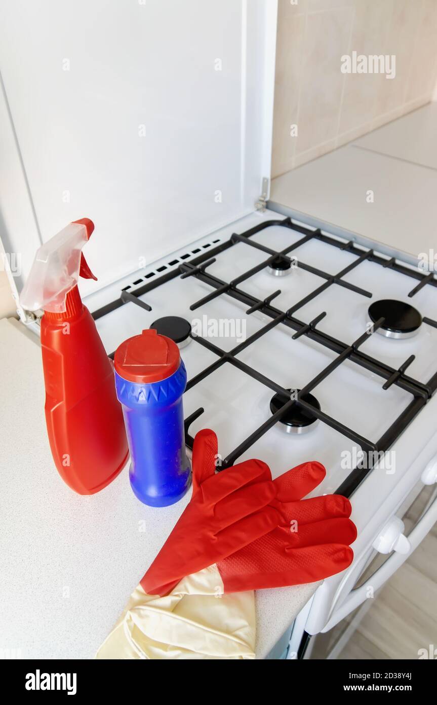 cleaning of the kitchen. Cleaning the gas stove with detergents and
