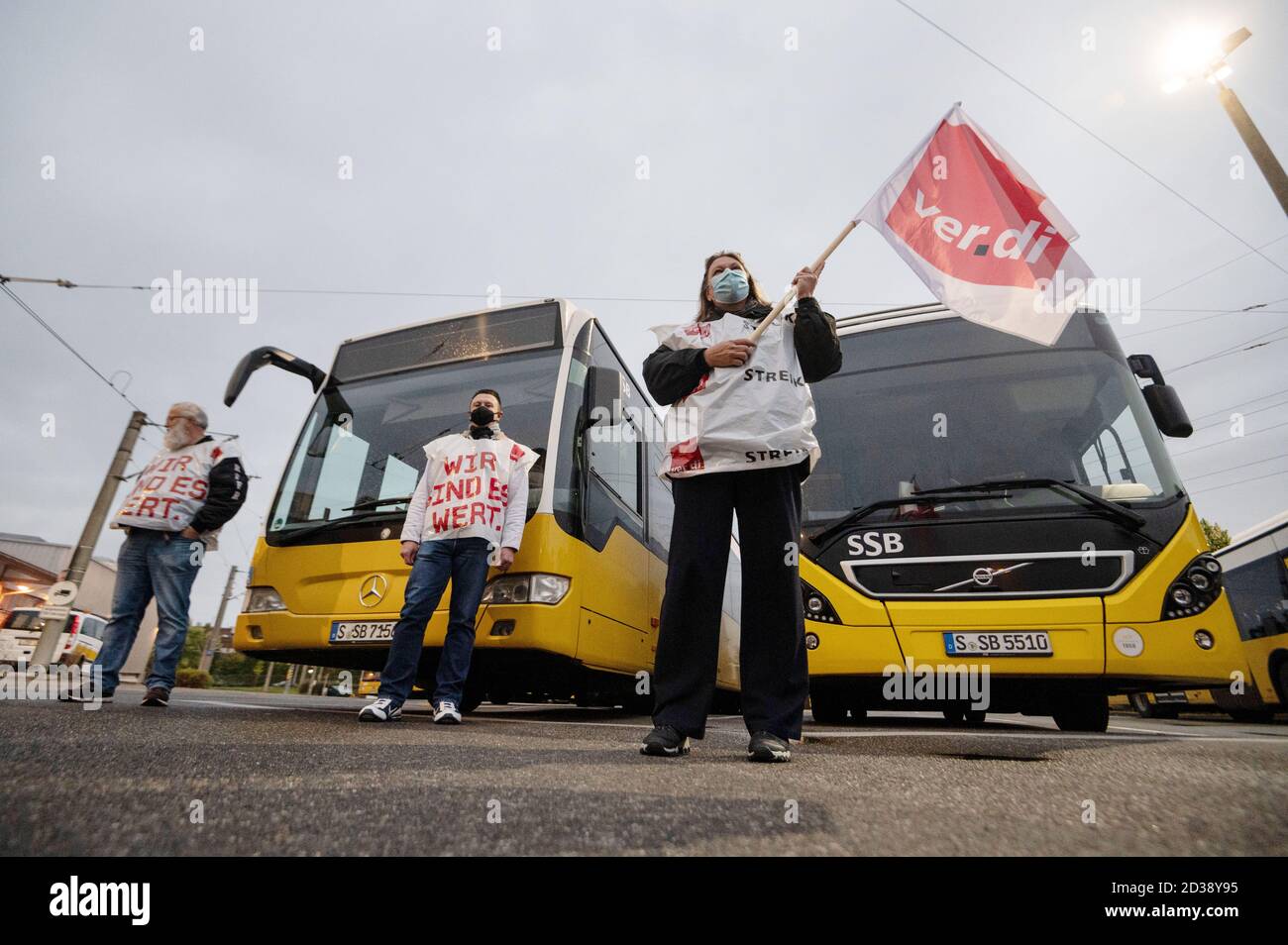 Stuttgart, Germany. 08th Oct, 2020. Employees of the Stuttgarter  Straßenbahnen AG (SSB) are standing in front of buses during a warning  strike in the bus depot. The trade union Verdi increases the