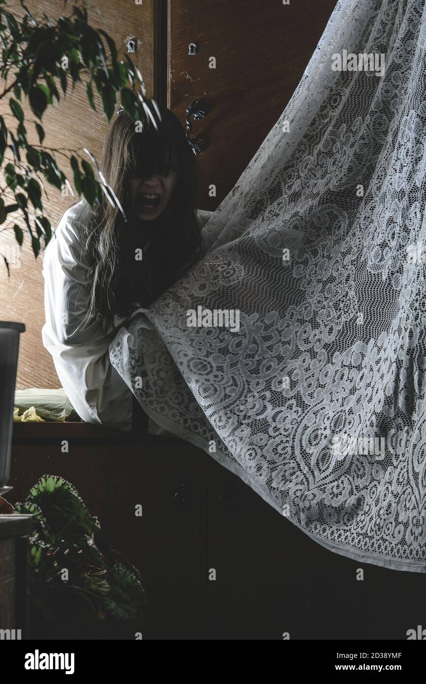 Demon possessed little girl at night. Mad scary girl at dark night. Horror background with child