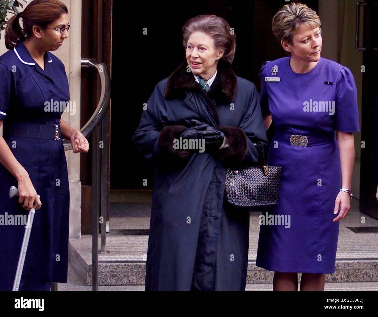 Britain's Princess Margaret (C) is helped by nurses as she leaves the King Edward VII Hospital in London after responding well to treatment January 20, 2001. The Princess has made an enormous improvement after being admitted to the hospital for suffering from a severe loss of appetite after having a suspected second stroke just before Christmas, she is expected to go to Kensington Palace and will rejoin the Queen at Sandringham on Monday.  JE/BR Stock Photo