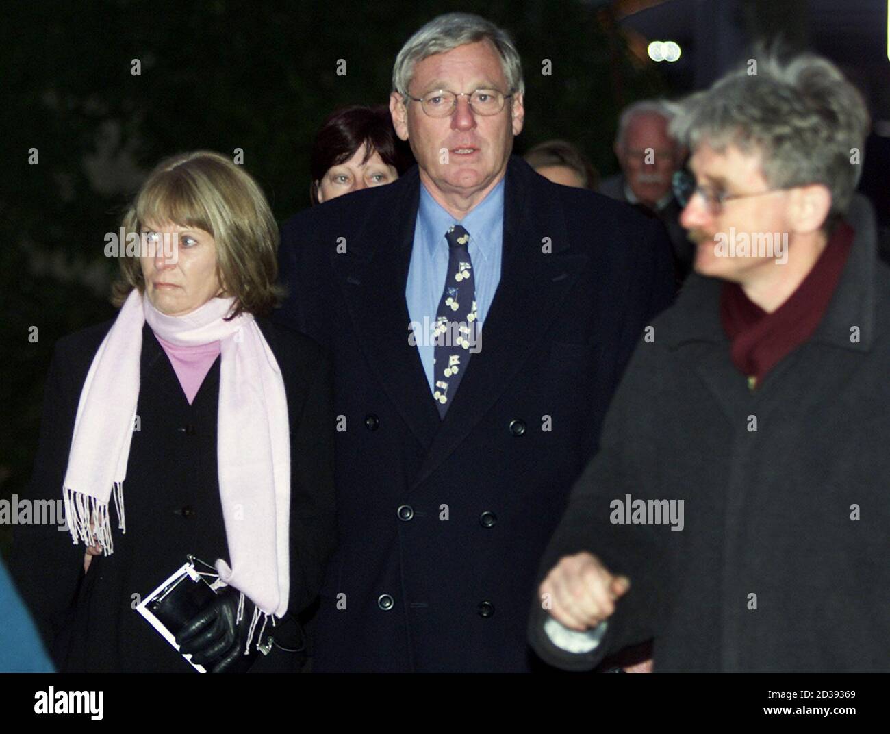 PARENTS FROM AUSTRALIA ARRIVE FOR PRONOUNCING OF JUDGEMENTS AGAINST MEMBERS OF WILDWATER ADVENTURE COMPANY IN INTERLAKEN.   Bronwyn (L) and Paul Scott Smith (R) from Australia, who lost her daughter Briana in the canyoning disaster in summer 1999, arrive together with lawyer Eric Blindenbacher (R) for the pronouncing of judgements in Interlaken December 12, 2001. The court was due to hand down verdicts in manslaughter trial against eight members of the Swiss company that organised a disastrous wildwater adventure in which 18 thrill-seekers and three guides died. REUTERS/Marcus Gyger REUTERS Stock Photo