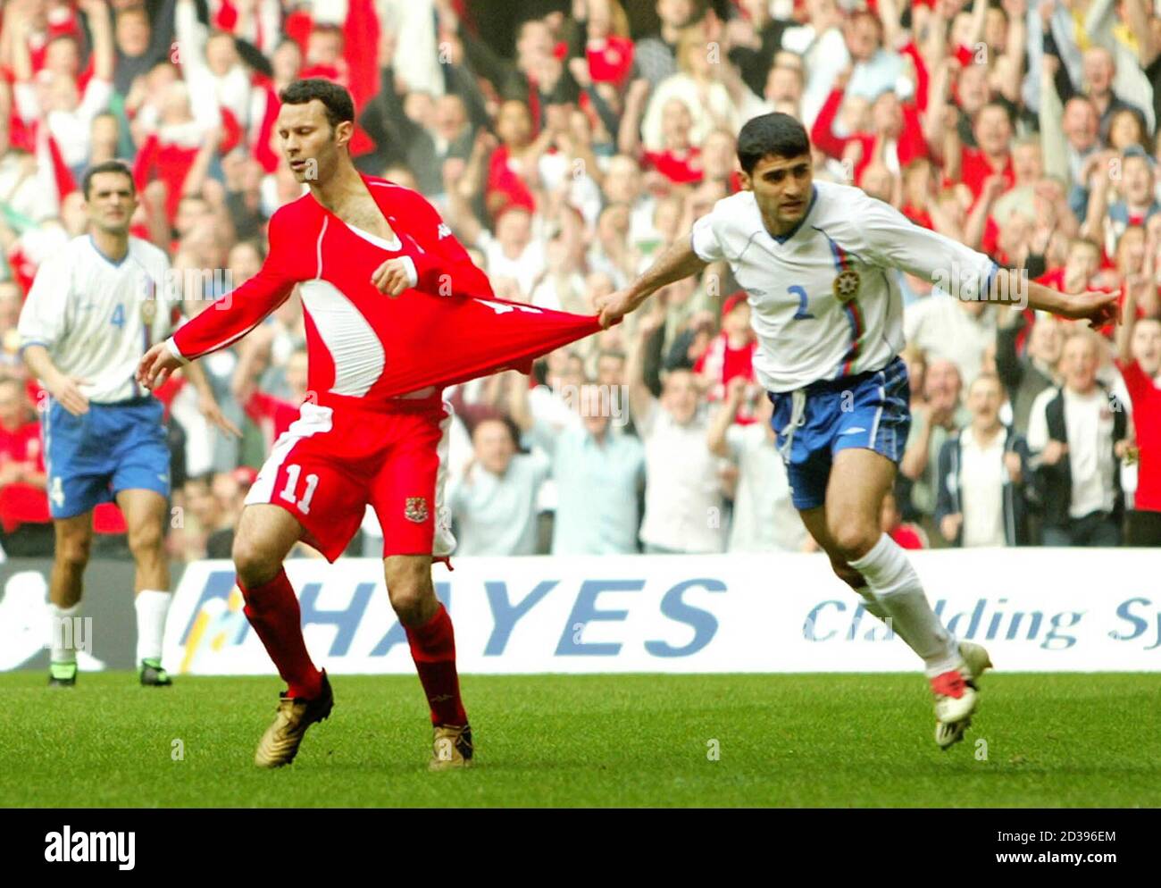 Ryan Giggs of Wales (L) has his shirt pulled by Azerbaijan's Fizuli Mahammadov (R) after scoring Wales's fourth goal in their Euro 2004 qualifying group nine match at the Millennium Stadium in Cardiff, March 29, 2003. REUTERS/Peter Macdiarmid  PKM/ASA Stock Photo