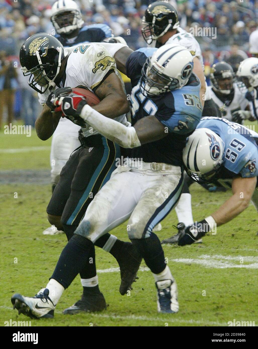 Jacksonville Jaguars Running Back Fred Taylor (L) Is Tackled By Tennessee Titans Linebackers Keith Bulluck (53) And Peter Sirmon (59) During First Half Nfl Action In Nashville, Tennessee, November 16, 2003, At