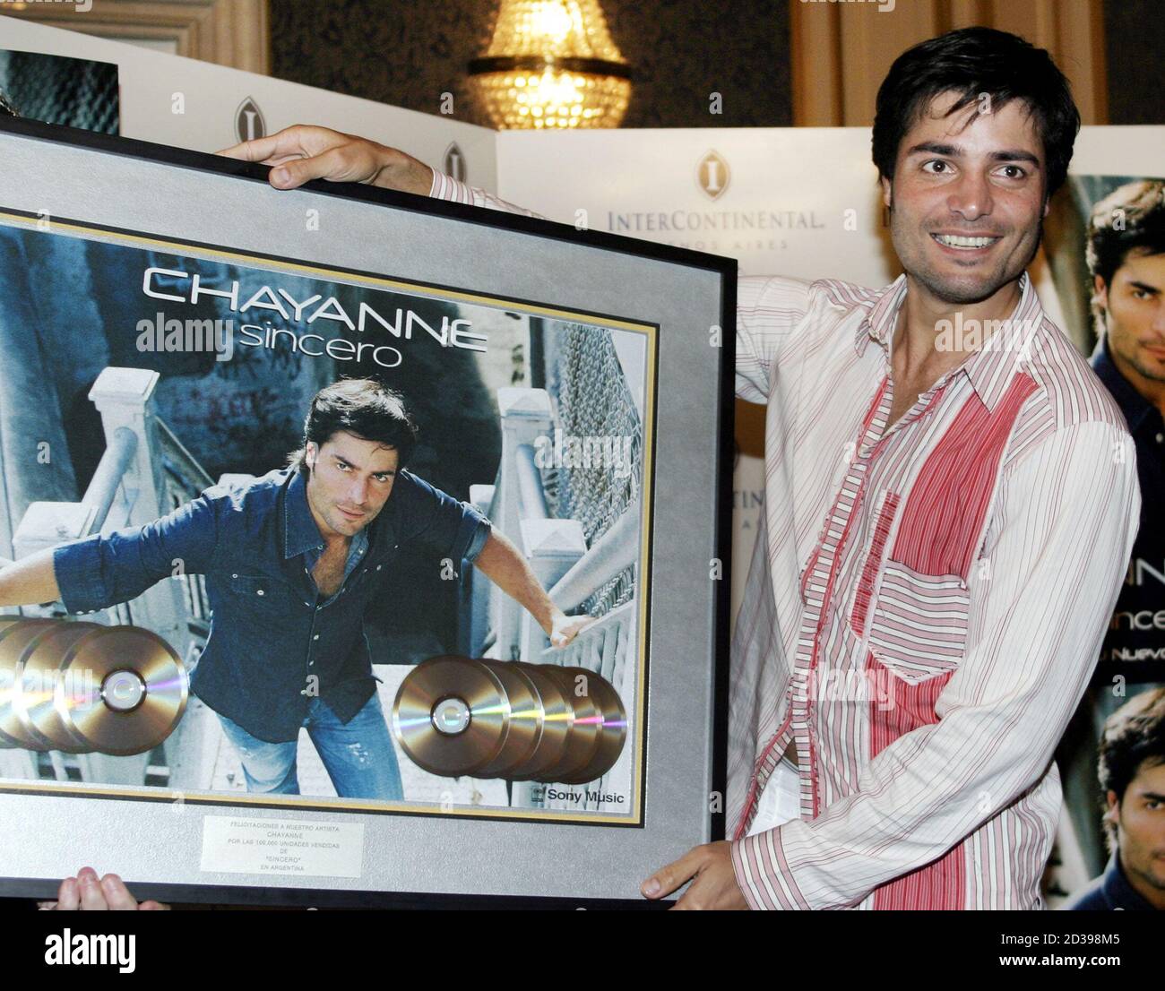 Puerto Rican singer and actor Chayanne, born Elmer Figueroa Arce, shows the cover of his latest album "Sincero" during a press conference in Buenos Aires, Argentina, March 8, 2004. Chayanne announced a North American tour that will take him across the United States through April, 2004. REUTERS/Enrique Marcarian  EM Stock Photo