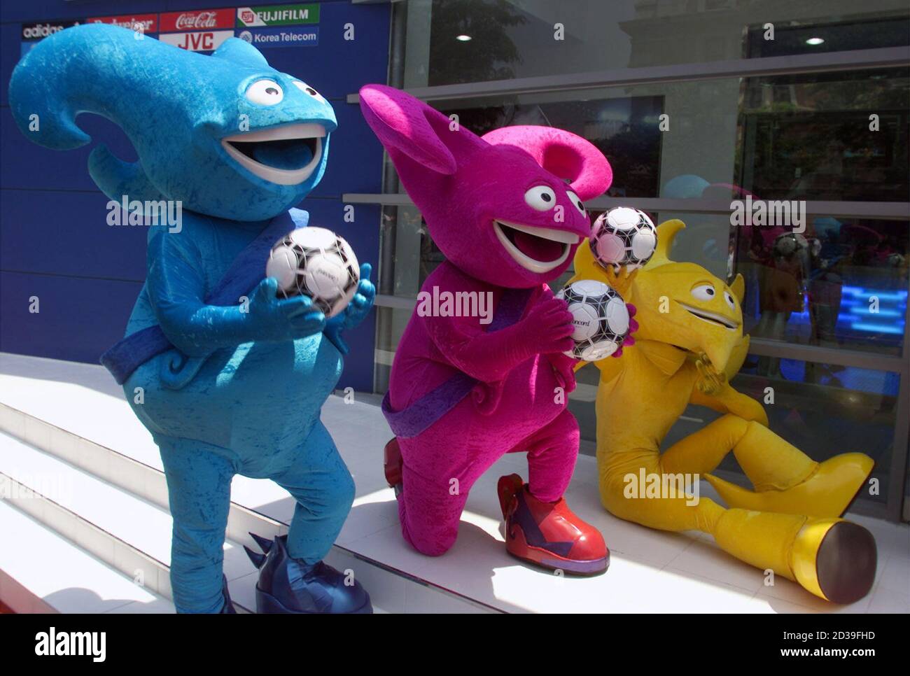 The three official mascots of the 2002 World Cup soccer tournament, (L-R)  Nik, Kaz and Ato, gather to promote the event at a press conference which  was attended by FIFA President Sepp