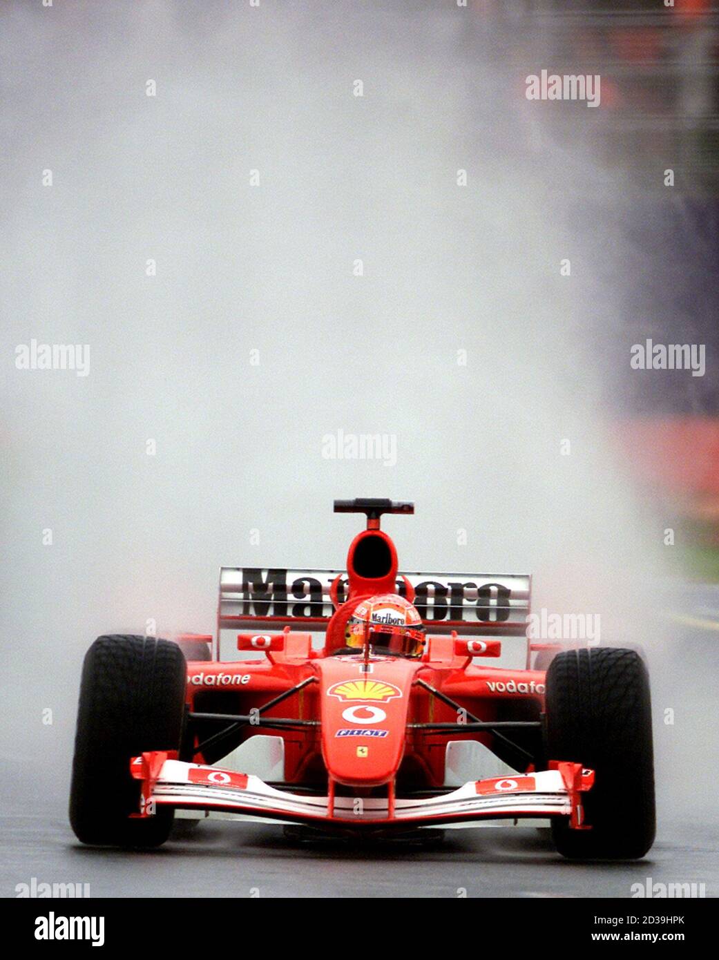 Ferrari team driver Michael Schumacher from Germany drives during wet  conditions during the qualifying session in Melbourne March 2, 2002. Rubens  Barrichello from Brazil qualified on pole ahead of teammate Michael, with