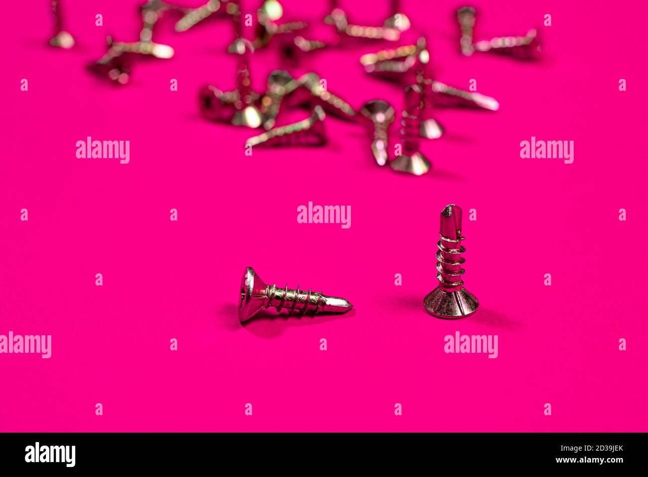 Self-cutters on a bright pink background. Furniture and parts for repair and construction Stock Photo