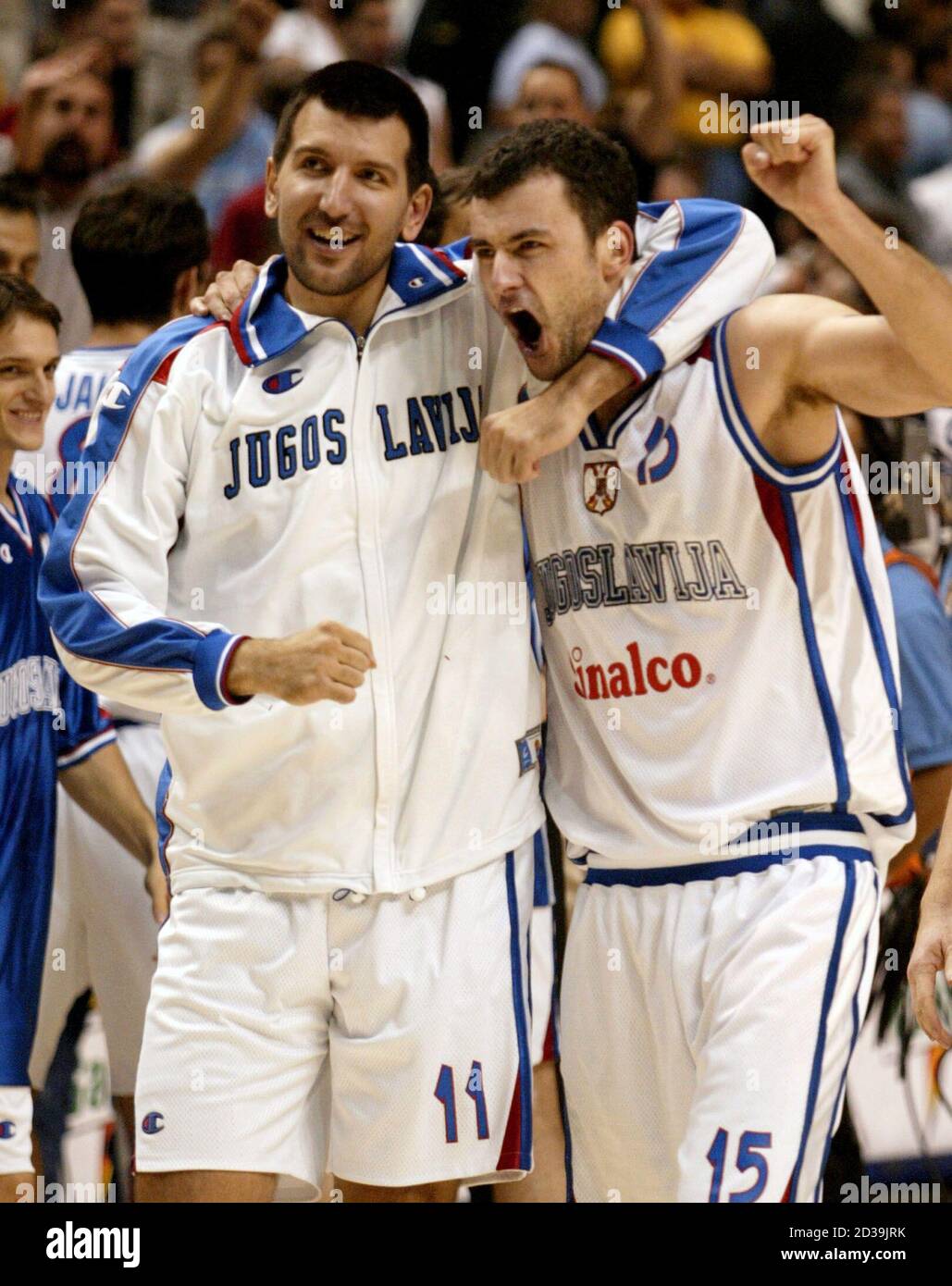 Yugoslavia's Predrag Drobnjak (L) and teammate Milan Gurovic celebrate  after they defeated the United States 81-78 during the quarter-final round  of the 2002 World Basketball Championships in Indianapolis, Indiana,  September 5, 2002.