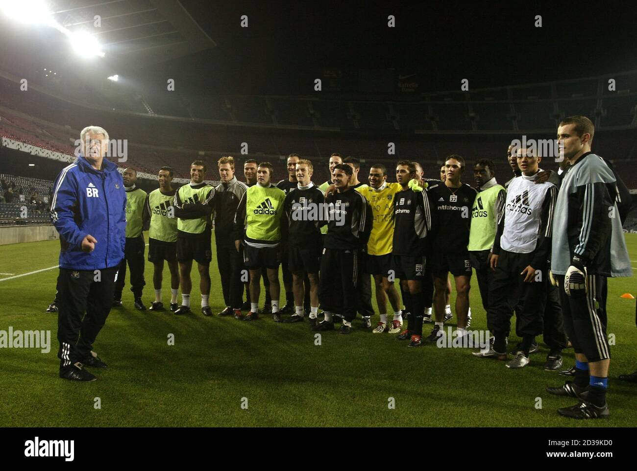 Newcastle United manager Sir Bobby Robson (C) talks to his players during  training at the Nou Camp Stadium in Barcelona, Spain December 9, 2002.  Newcastle United are due to face FC Barcelona