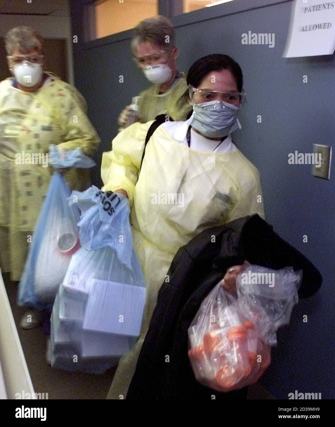 Nurses In Full Protective Clothing Move Bags Of Medical Supplies Prior To Opening The Fourth Severe Acute Respiratory Syndrome Sars Assessment Clinic In Ontario At The Trillium Hospital In The West End Nurses In Full Protective Clothing Move Bags Of Medical Supplies Prior To Opening The Fourth Severe Acute Respiratory Syndrome Sars Assessment Clinic In Ontario At The Trillium Hospital In The West End