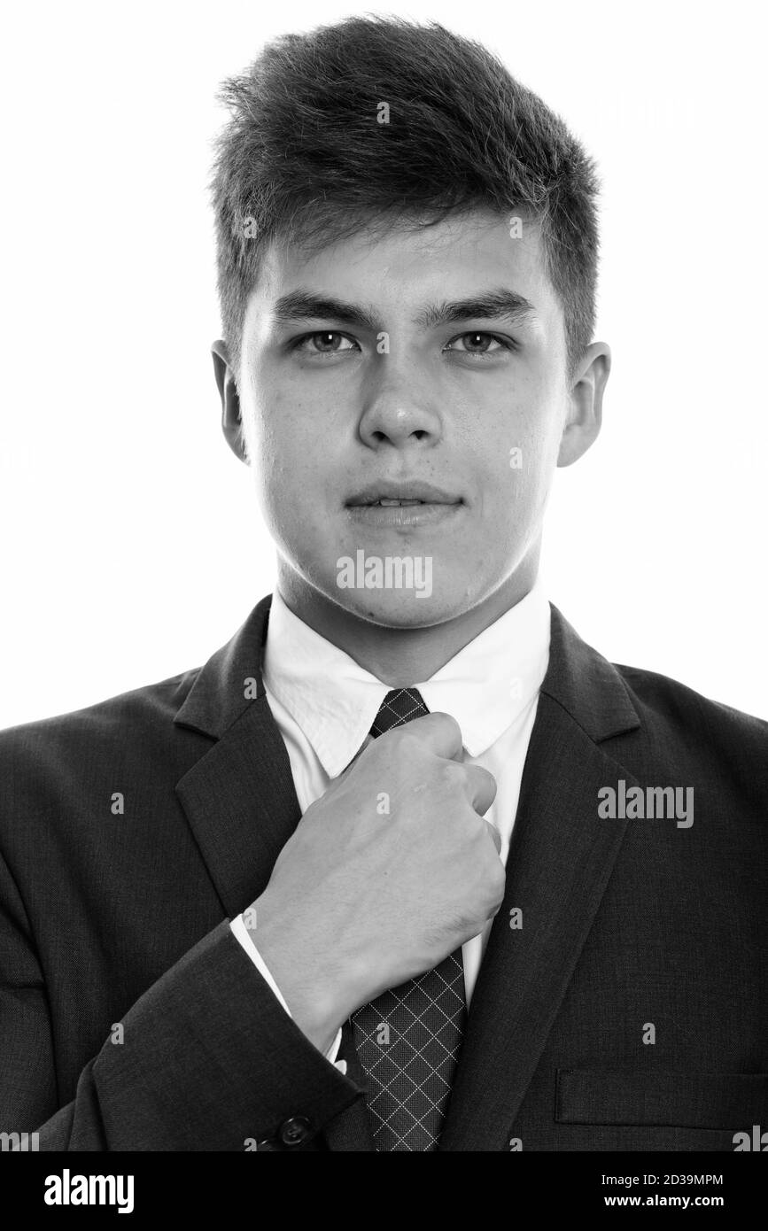 Face of young handsome businessman fixing tie Stock Photo