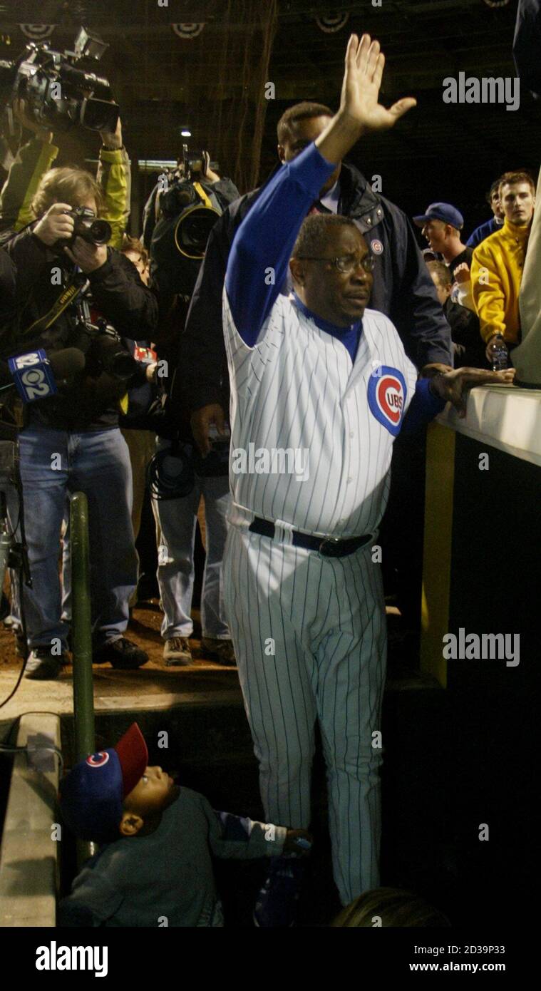 Chicago Cubs manager Dusty Baker wave to the crowd as he enters the dugout  after his team was upset by the Florida Marlins 9-6 in Game 7 of the NLCS  Championship series