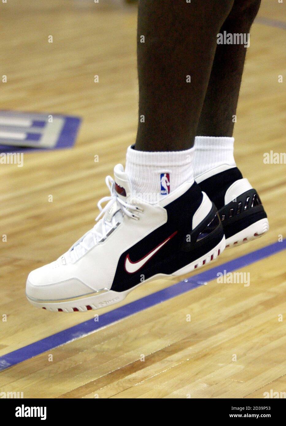 Cleveland Cavaliers' LeBron James warms-up in his new basketball shoes  before making his NBA debut against he Sacramento Kings in Sacramento,  California October 29, 2003. The 18-year-old 6-foot-8 James, first pick in