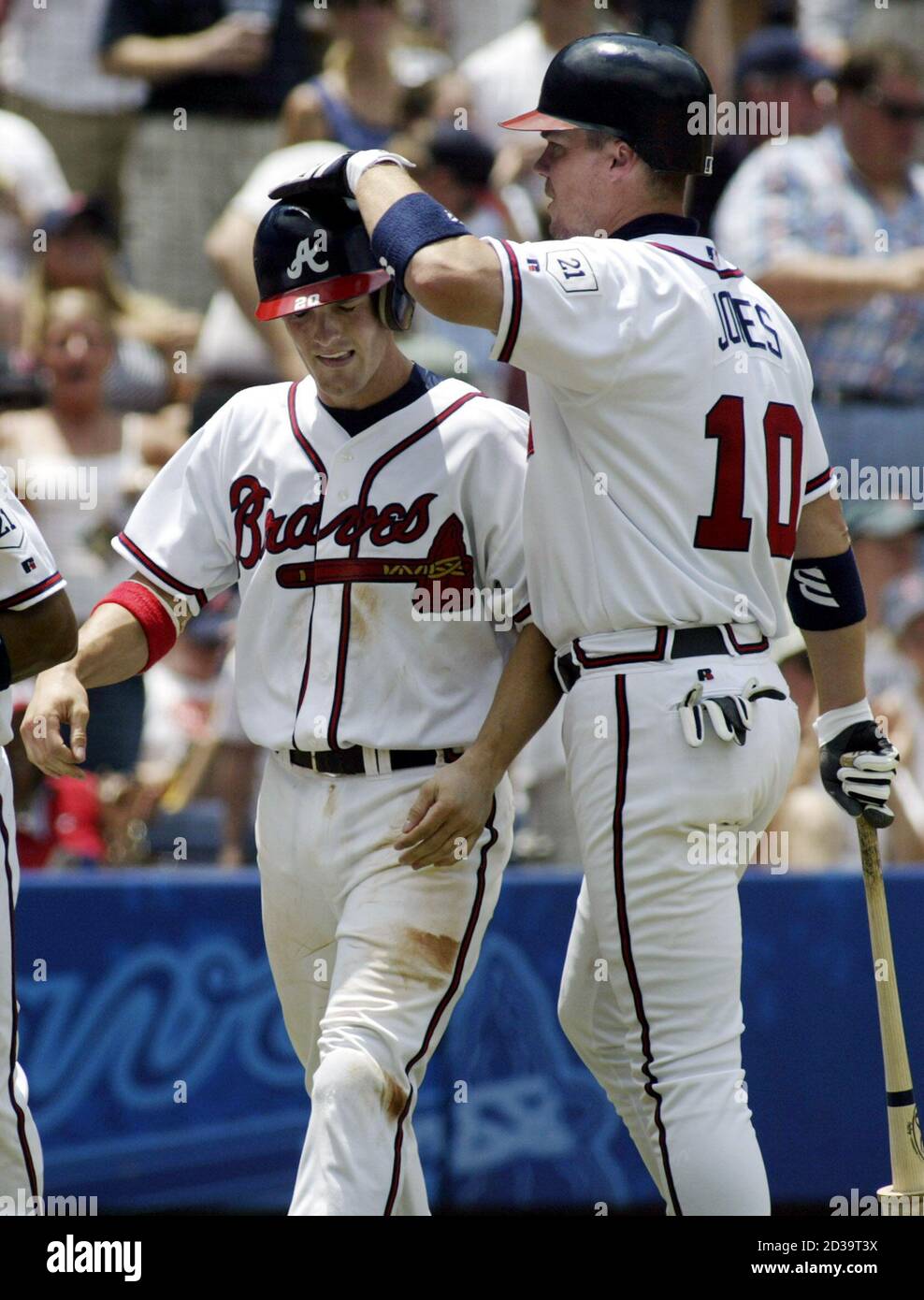 Atlanta Braves' Chipper Jones (R) congratulates teammate Nick Green after  Green scored on a hit by J.D. Drew in the fifth inning off Boston Red Sox  pitcher Derek Lowe, July 4, 2004.