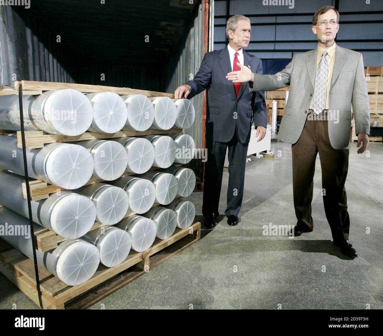 U.S. President George W. Bush tours a display of materials and equipment collected in Libya with the Manager of National Security Advanced Technologies, Jon Kreykes (R), in the Fusion Building of the Oak Ridge National Laboratory in Tennessee, July 12, 2004. Stock Photo
