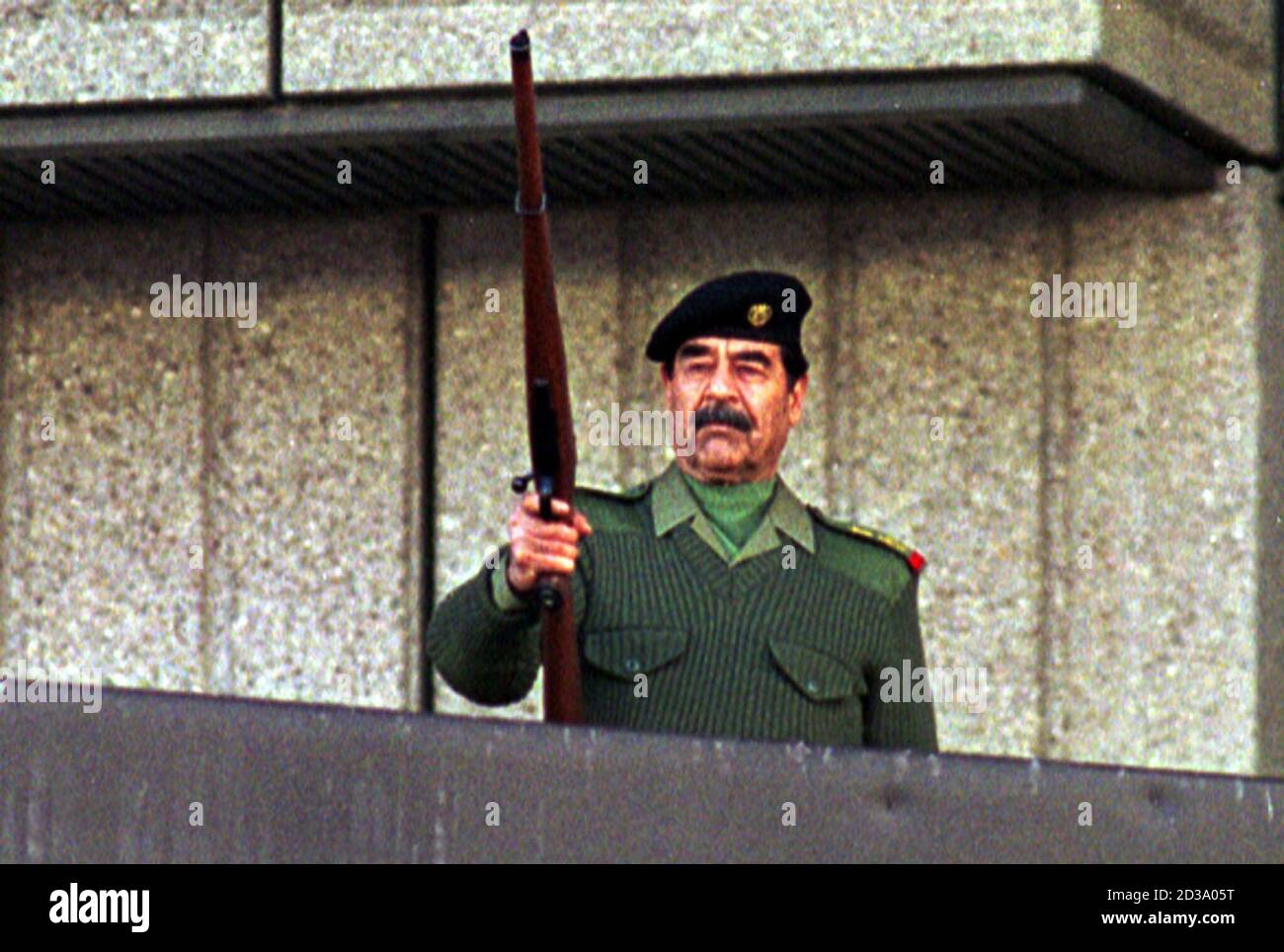 President Saddam Hussein Fires A Rifle In The Air As He Salutes Iraqi Volunteers Who Have Offered To Fight With Paleastinians Against Israel Troops During A Military Parade In Baghdad On November