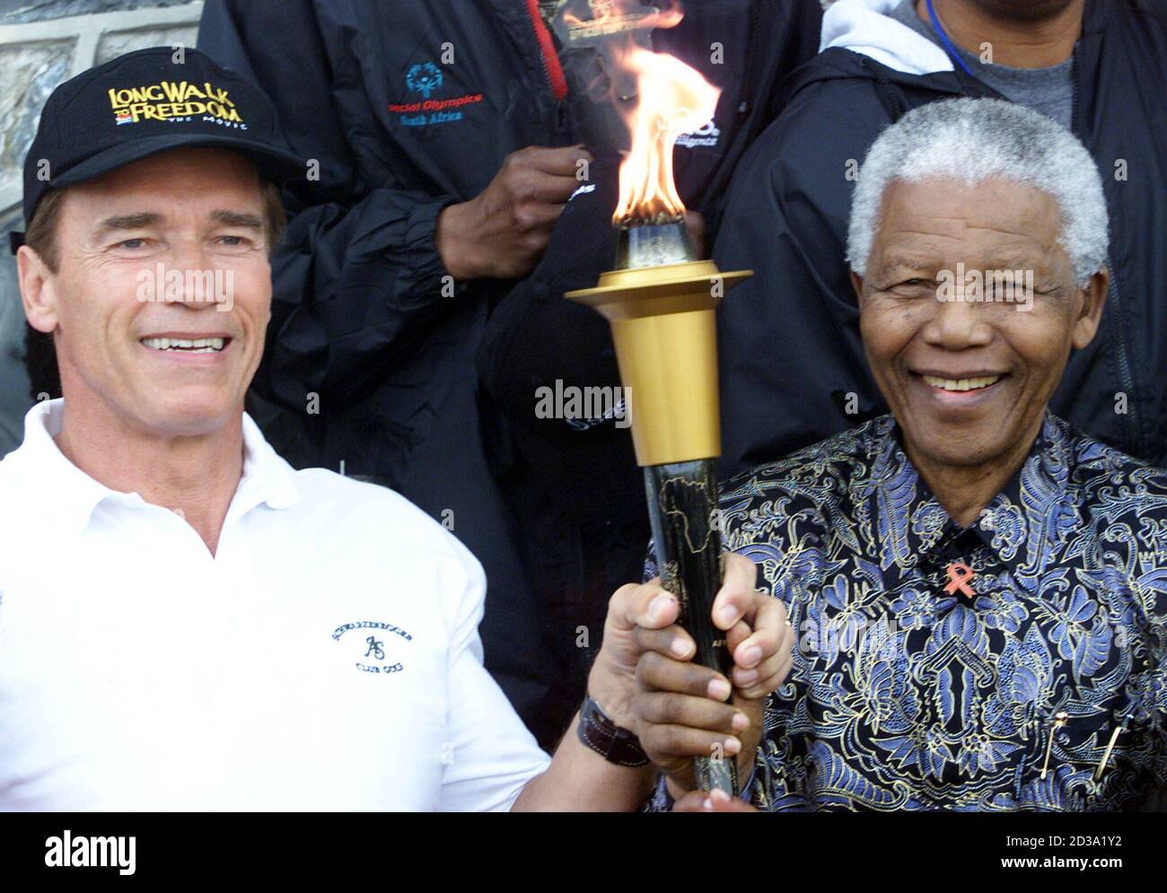 Former President Nelson Mandela and actor Arnold Schwarzenegger hold a  symbolic "Flame of Hope" at a ceremony outside Mandela's old prison cell on  Robben Island. July 12, 2001. The event was part