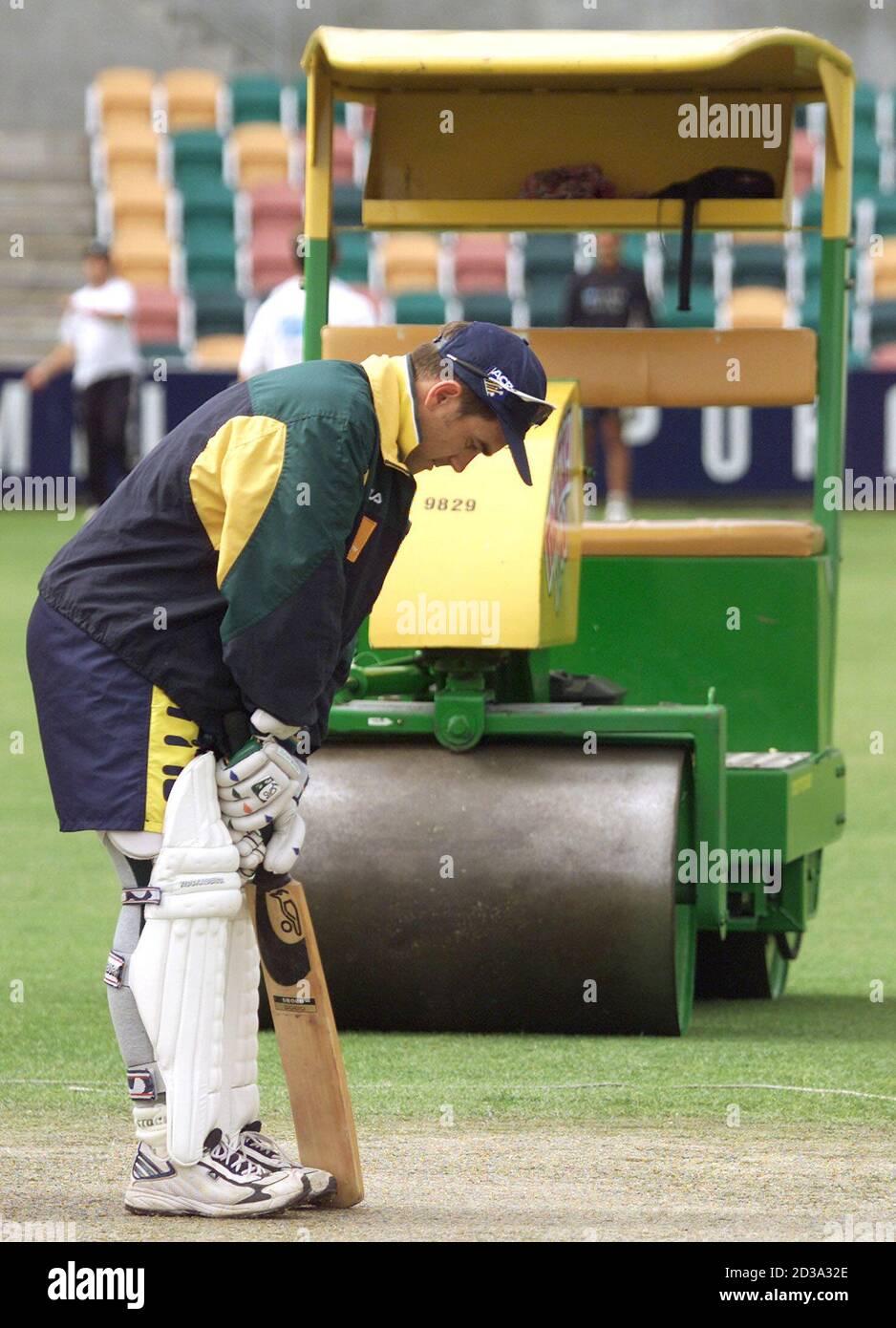 Australia's Justin Langer tests the Bellerive Oval wicket in Hobart as the ground's roller lies idle in the background November 21, 2001. New Zealand play Australia in the second cricket test starting Thursday. The first test ended in a draw. REUTERS/Will Burgess  WB/JD Stock Photo