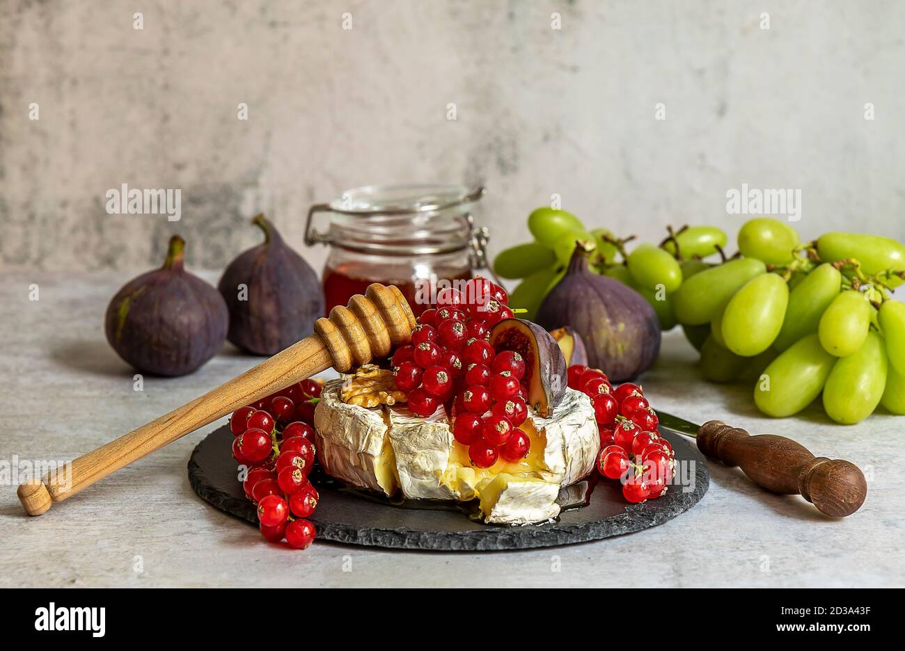Oven baked Camembert with berries, honey, and figs Stock Photo Alamy