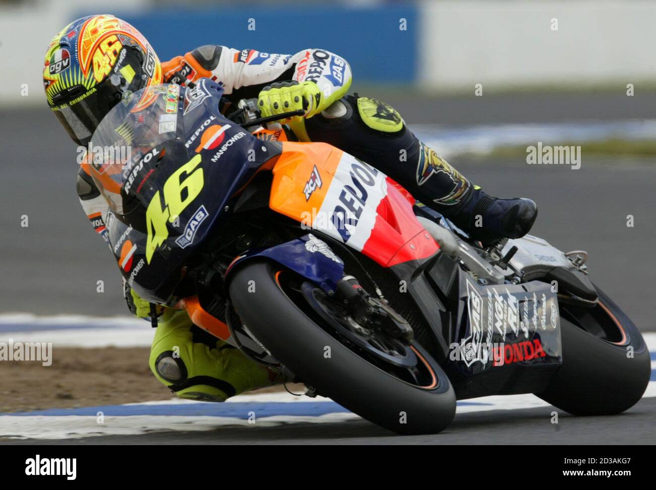 Italy's Valentino Rossi leans his Honda through a chicane of the Donington  Park circuit during the qualifying for the British motorcycling Grand Prix  at Donington Park circuit July 13, 2002. Rossi took