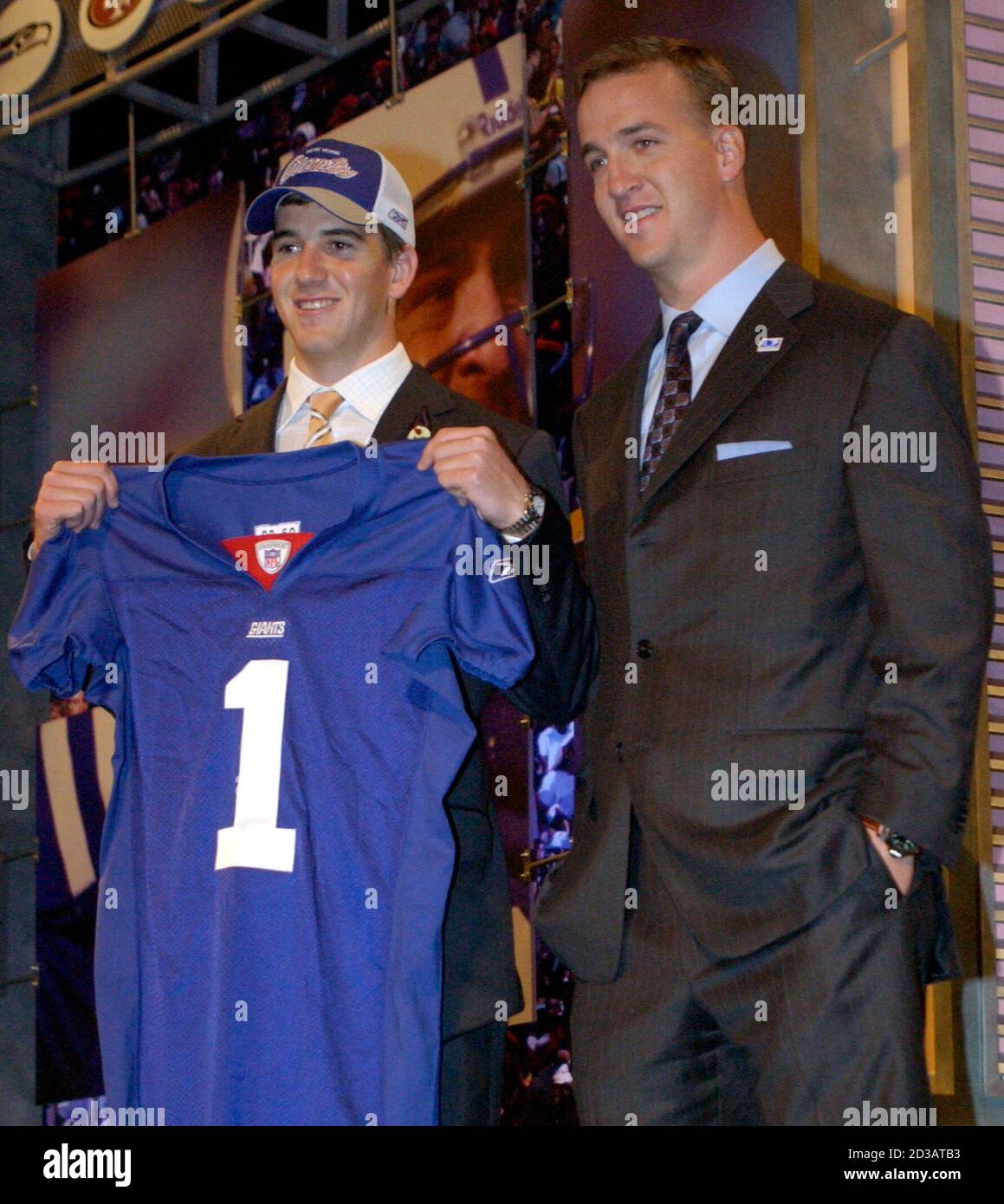 Quarterback Eli Manning (L), from the University of Mississippi, stands  with his brother, NFL quarterback Payton Manning, after Eli was chosen as  the first overall pick in the NFL Draft, at Madison