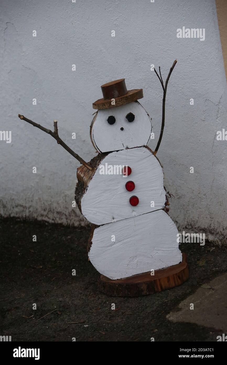 Wooden snowmen made from logs in various places Stock Photo