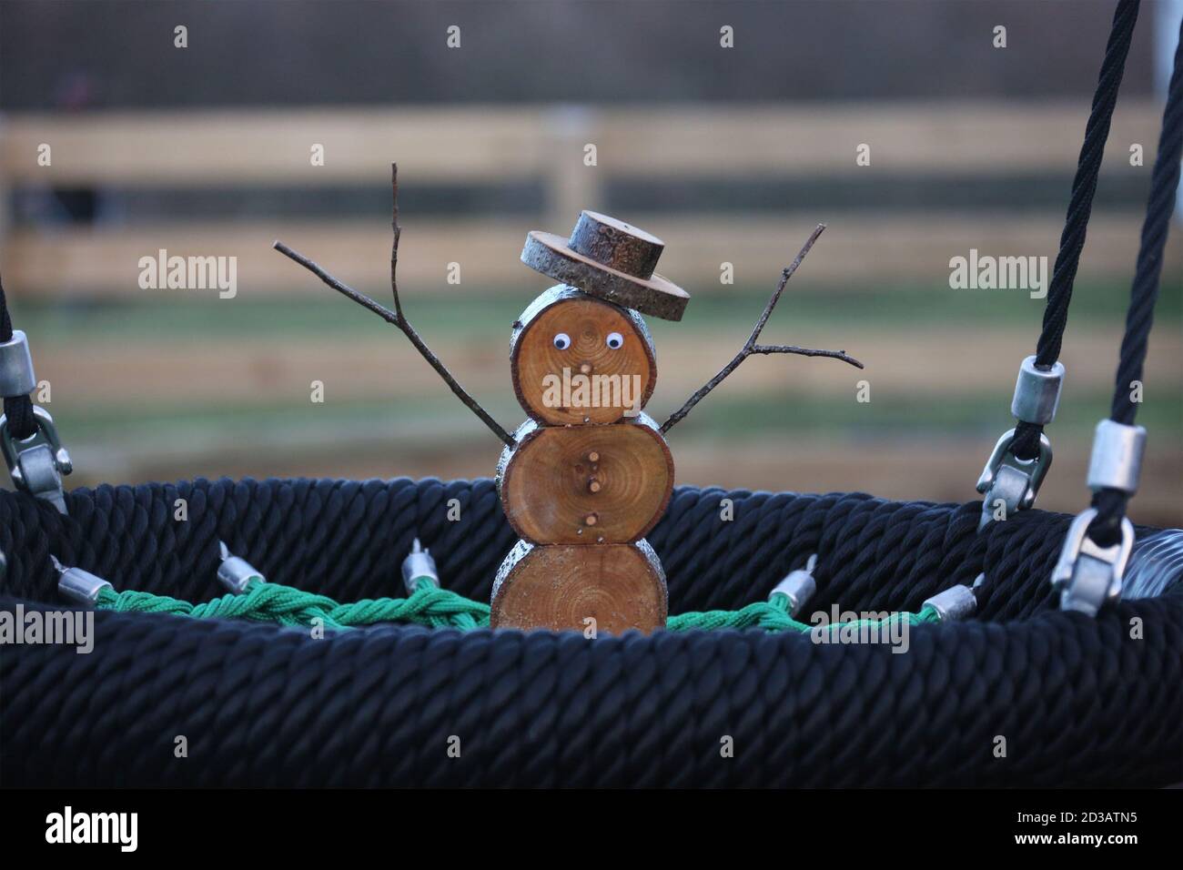 Wooden snowmen made from logs in various places Stock Photo