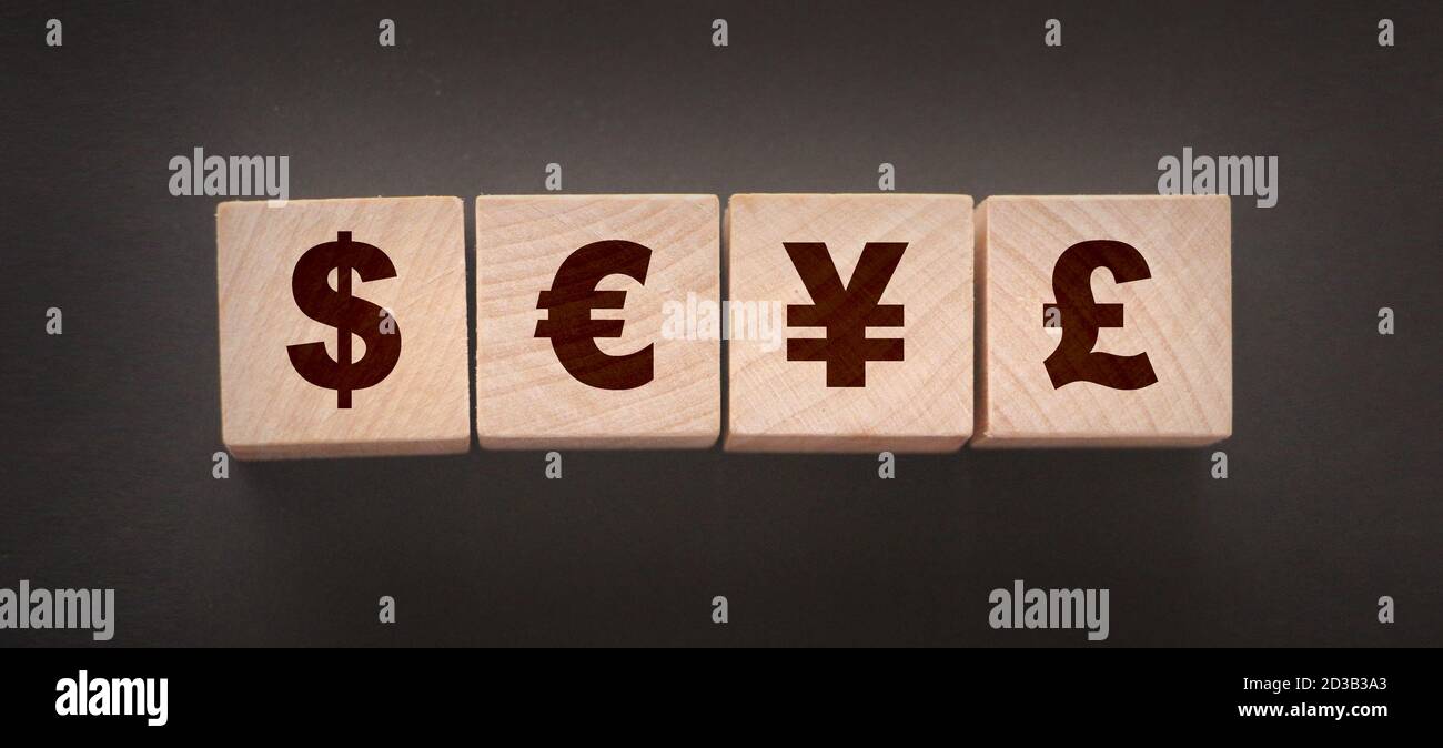 Dillar, euro, yen and pound on building blocks. wooden cubes with