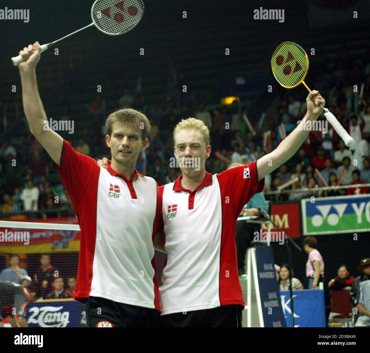 Denmark's Jonas Rasmussen (L) and Lars Paaske celebrate victory over  Chinese Cai Yun and Fu Haifeng during the final match of the mens double's  Thomas Cup badminton tournament in Jakarta on May