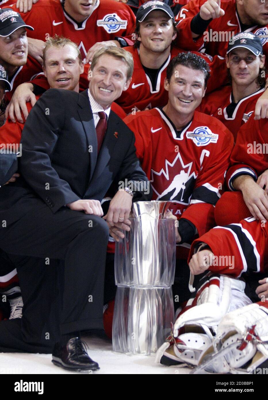 Team Canada executive director Wayne Gretzky and captain Mario Lemieux  celebrate with the team after defeating