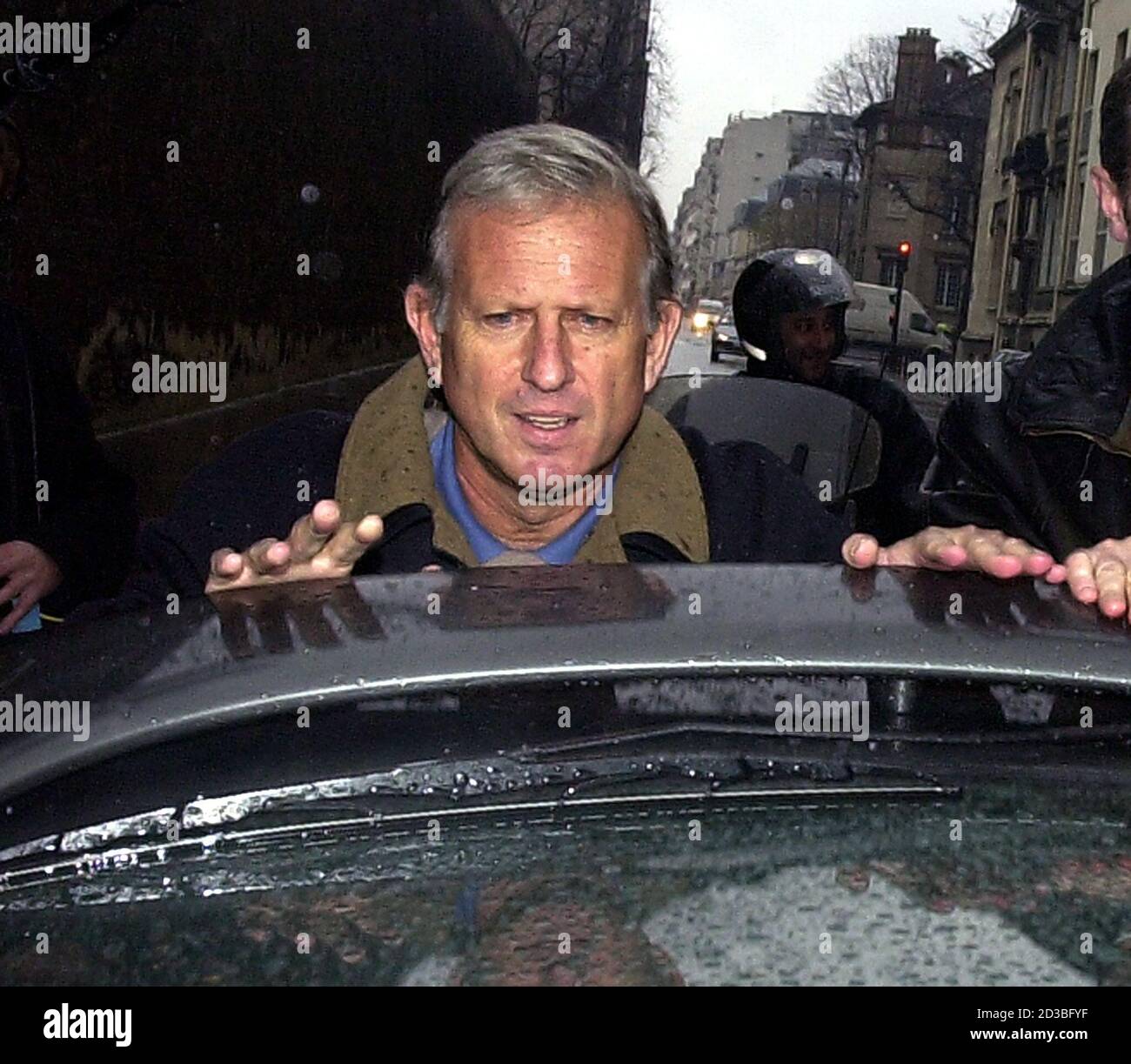 Former Cooperation Minister Michel Roussin  closes the trunk of his car as he leaves Paris's Sante prison December 6, 2000. Roussin was incarcerated and released on bail in connection with alleged party financing scams at Paris city hall. Stock Photo