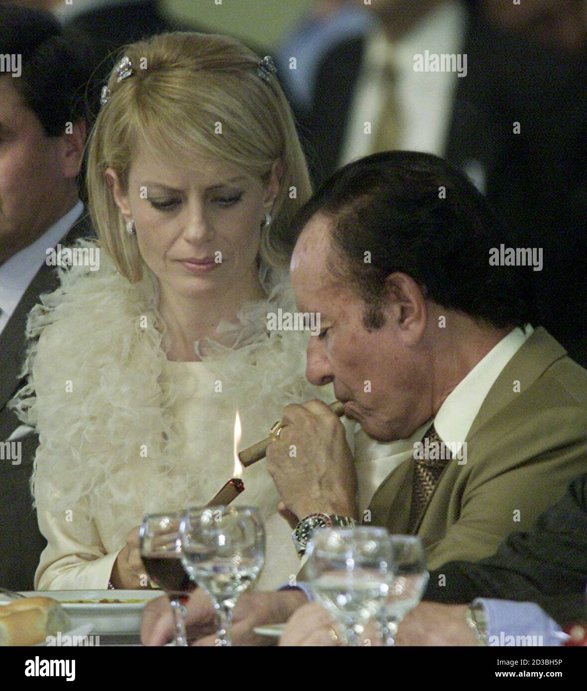 Chile S Former Miss Universe Cecilia Bolocco Uses A Burning Piece Of Cardboard To Light A Cigar For Her New Husband Former Argentine President Carlos Menem During A Party For Some 6 000 Guests