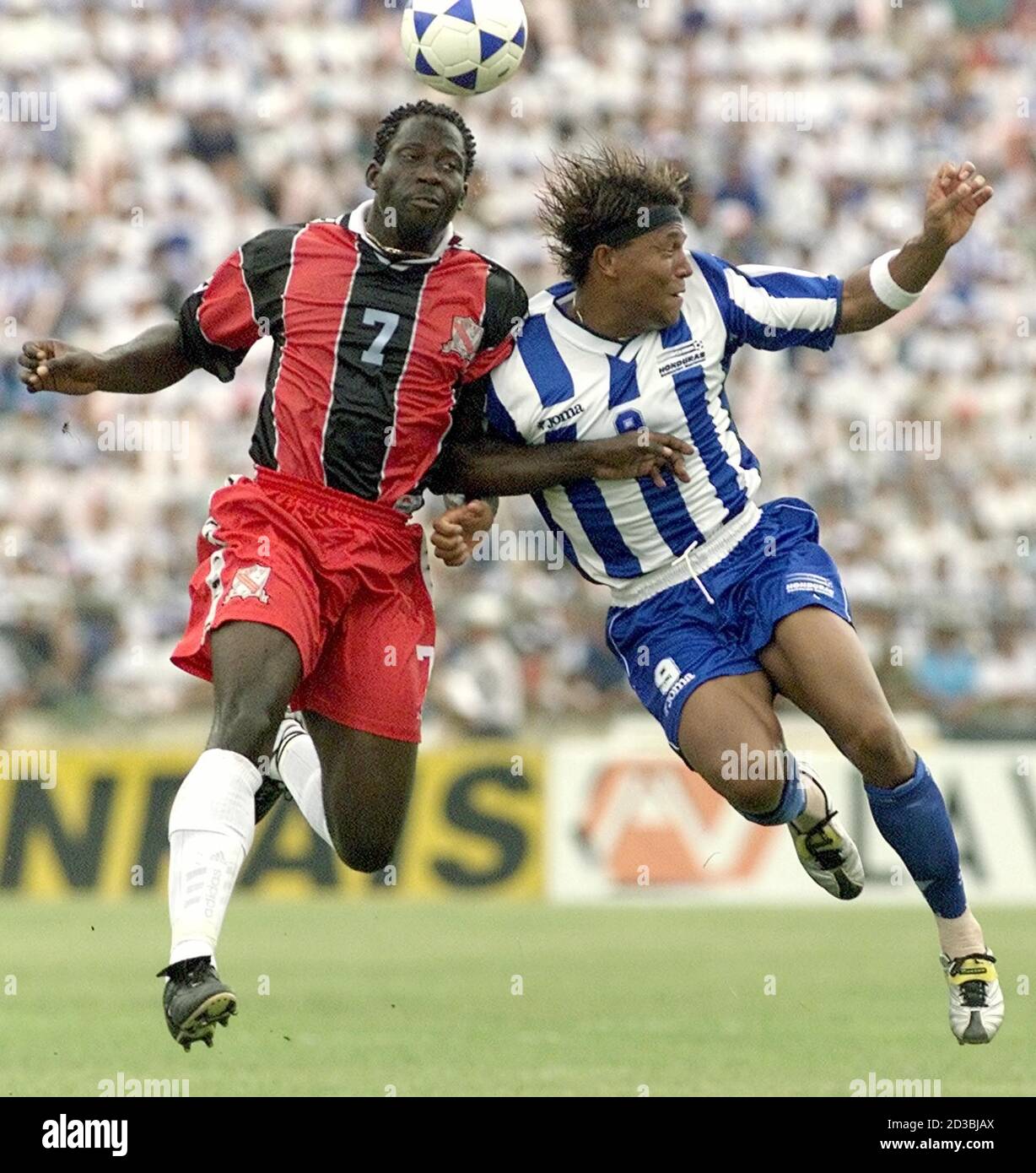 Honduran Player Carlos Pavon 9 Jumps For The Ball Against Trinidad S Keyeno Thomas 7 At Olimpico Metropolitano Stadium October 7 01 In San Pedro Sula Honduras Honduras Is Facing Trinidad And Tobago