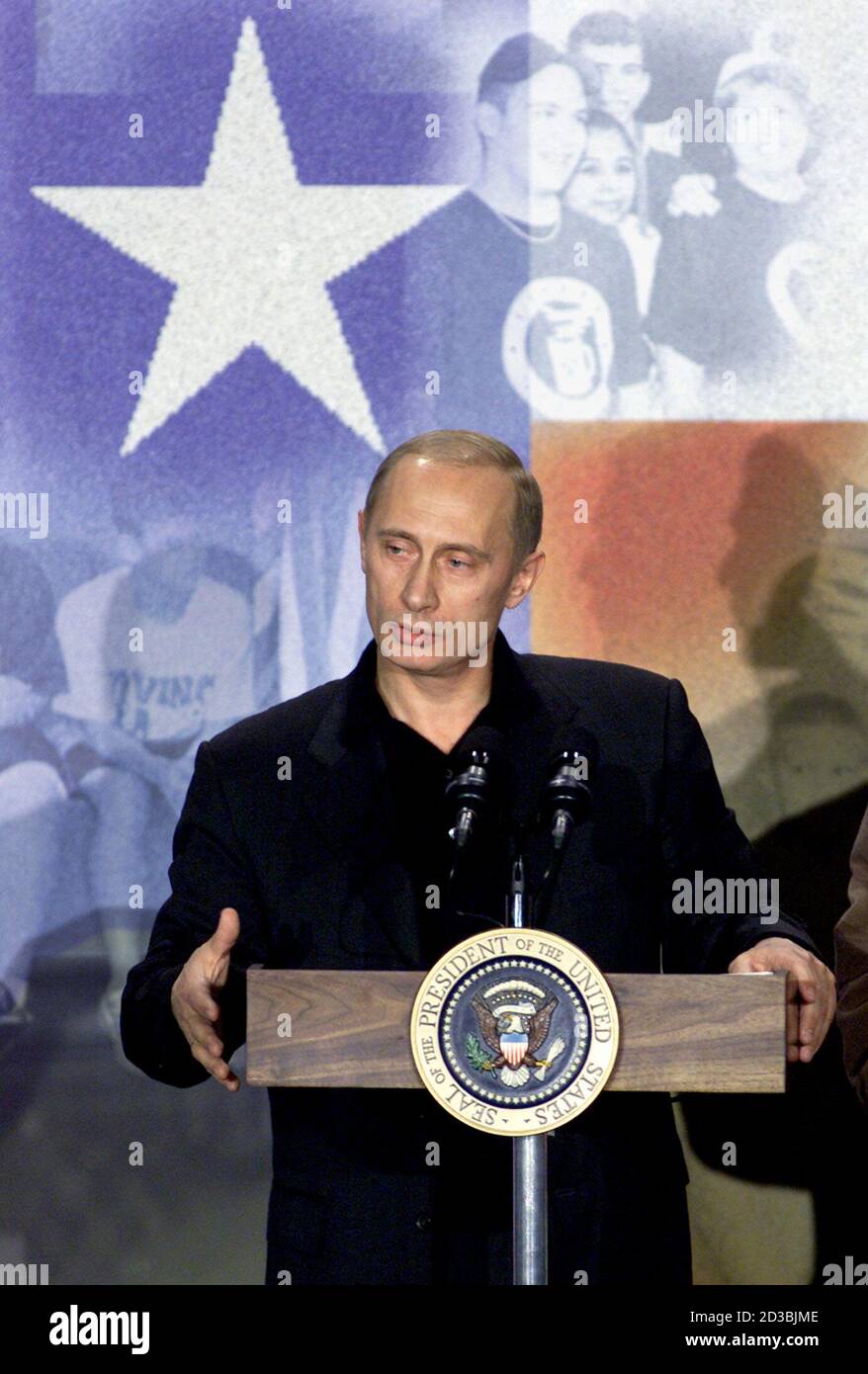 Russian President Vladimir Putin makes remarks at the Crawford High School in Crawford, Texas, November 15, 2001. Putin, who opposes U.S. President George W. Bush's intention to abandon the 1972 Anti-Ballistic Missile treaty and deploy a shield against incoming missiles from 'rogue' states, said the summit had not been a waste of time and the two leaders aimed to continue talks on the issue. REUTERS/Jeff Mitchell  JM/SV Stock Photo