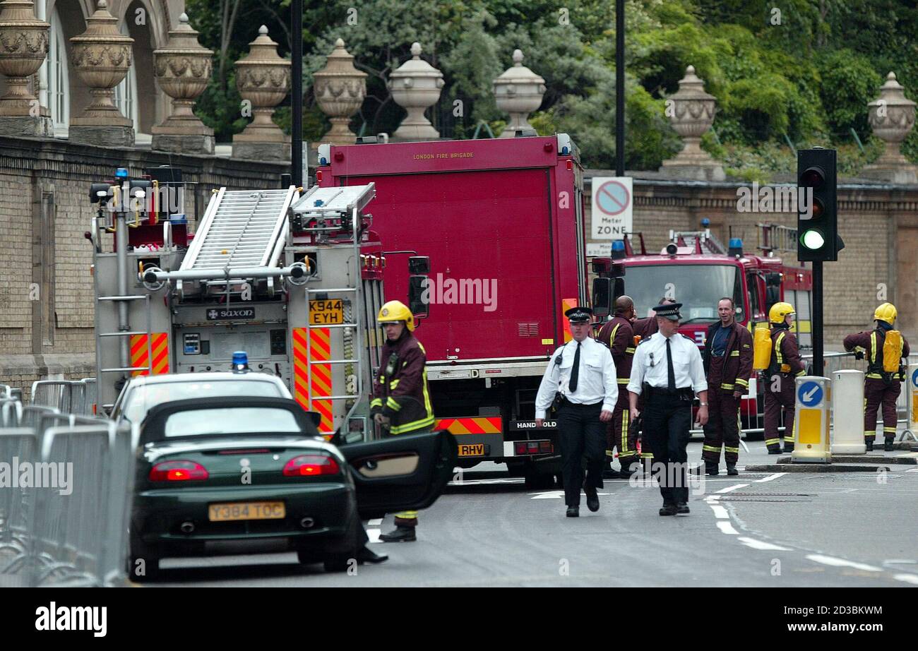 Firemen gather outside Buckingham Palace in London during a fire scare