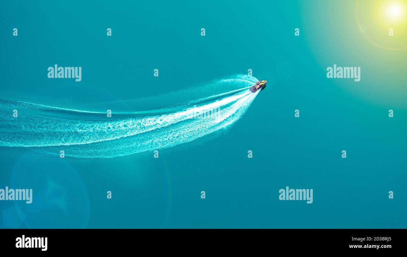 The jet ski travels at great speed through blue water Stock Photo - Alamy