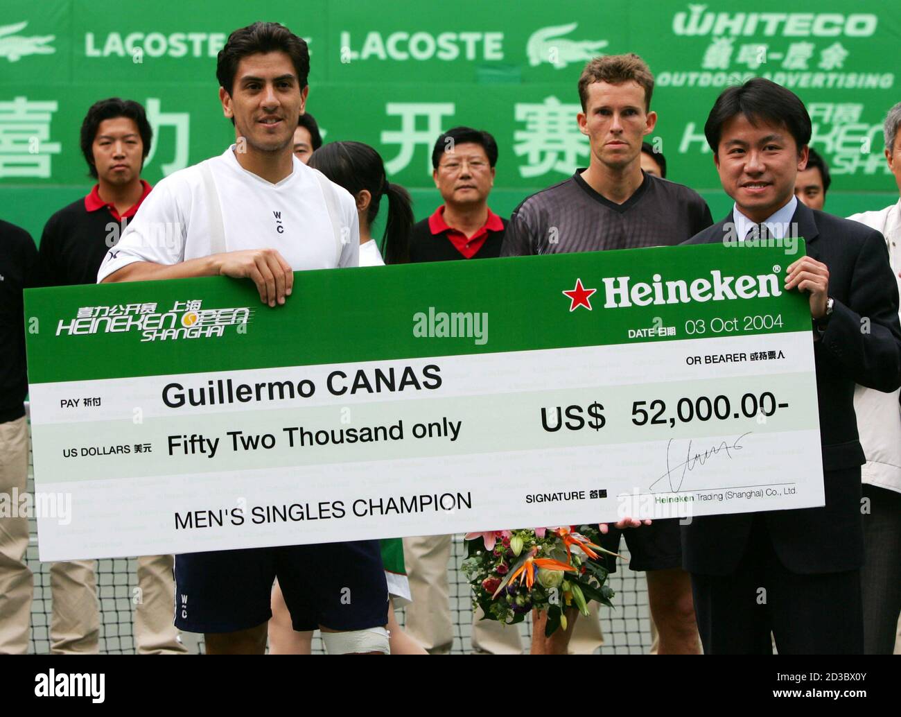 Guillermo Canas of Argentina receives cheque after winning his final match  against Lars Burgsmuller of Germany at Shanghai Open. Guillermo Canas (L)  of Argentina receives the champion's cheque of $52,000 after winning