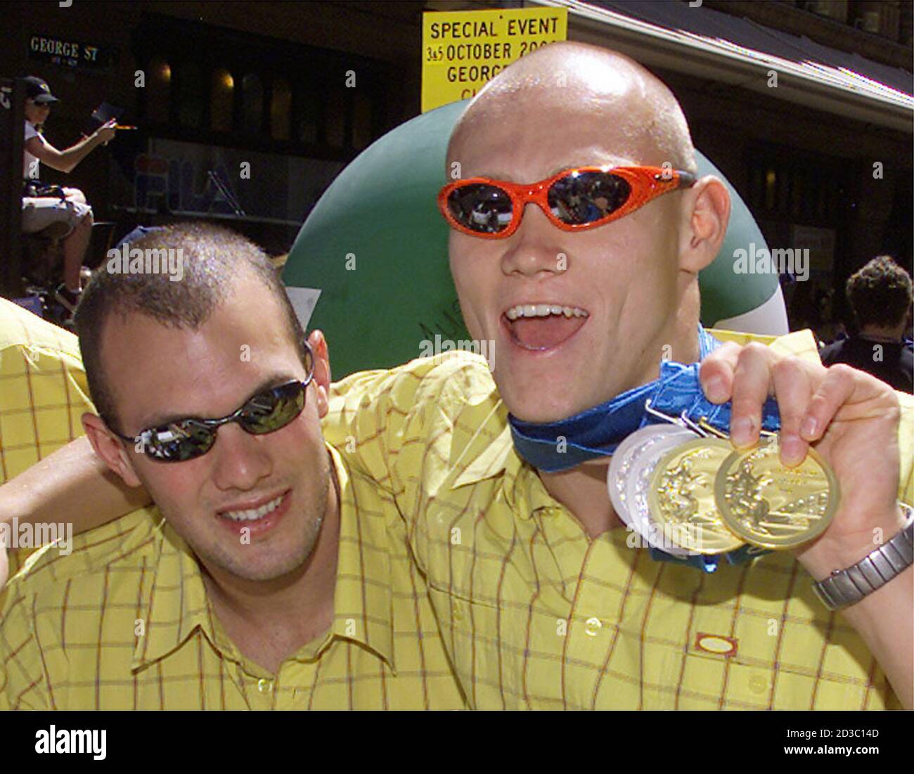 Australian Olympic Swimmer Michael Klim R Shows Off The Medals He Has Won At The Olympic Games As He Hugs Teammate Ashley Callus During A Parade Down The Main Street Of Sydney