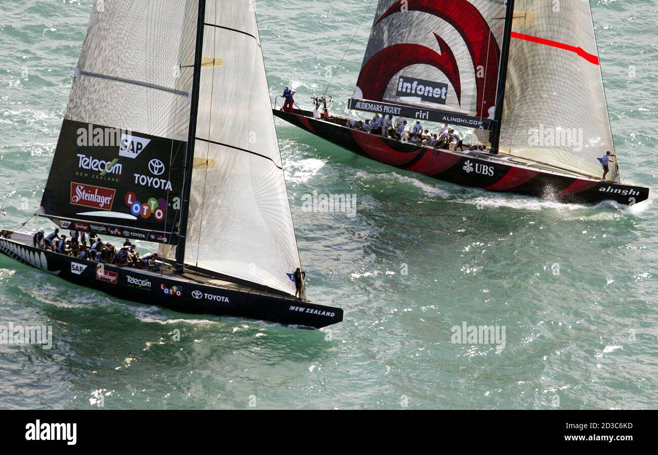 Defenders Team New Zealand (L) race challengers Alinghi from Switzerland to  the start line during the second race of the America's Cup on Auckland's  Hauraki Gulf February 16, 2003. REUTERS/Mark Baker MDB/RCS
