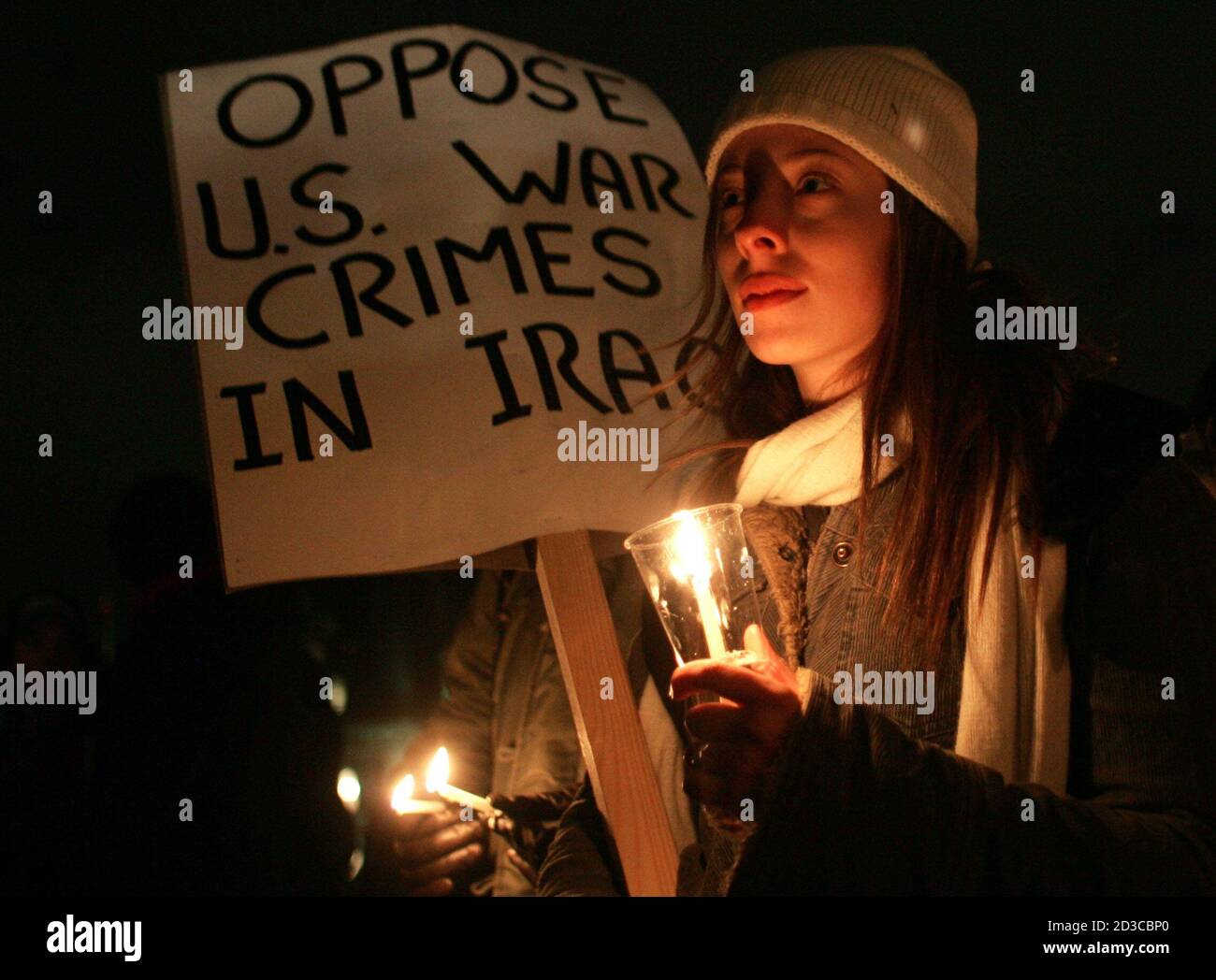 Kelly Gallagher of Montreal takes part in a candlelight vigil against the war in Iraq on Parliament Hill in Ottawa, November 30, 2004. The vigil was part of a day of protests against the visit of U.S. President George w.Bush. REUTERS/Christinne Muschi  PJ Stock Photo