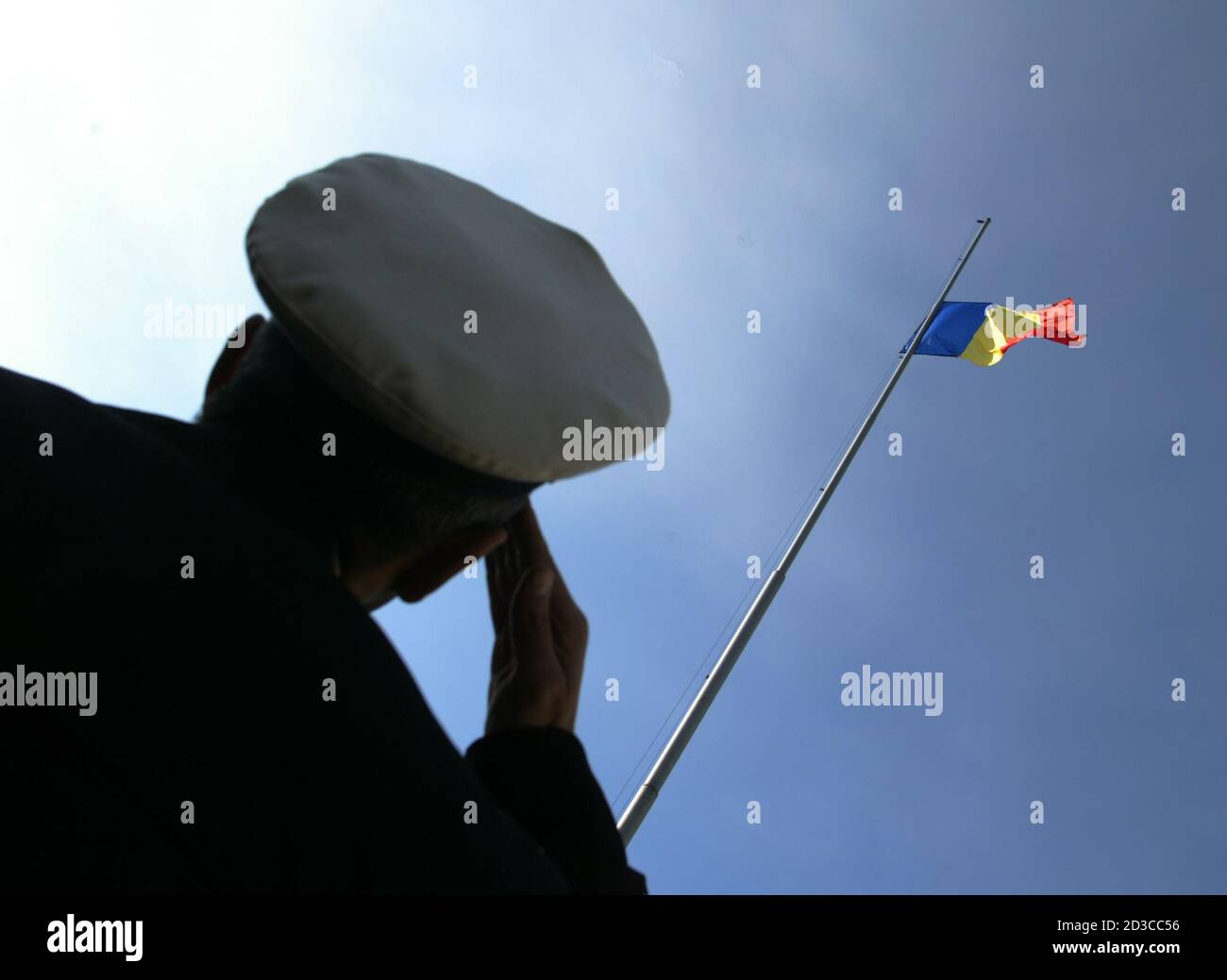 An Officer Salutes While Romania S Flag Flies At Half Mast In Tribute To The Victims Of The Asian Tsunami In Downtown Bucharest January 5 05 Countries Across Europe Observe A Three Minute Silence On